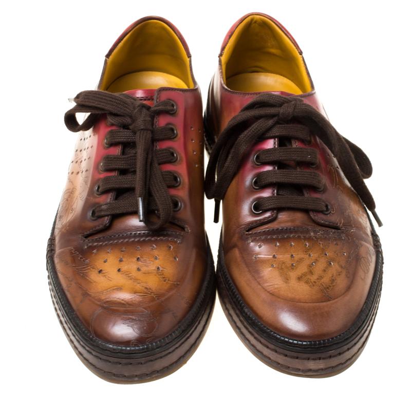 These brown ombre sneakers are designed to look slightly formal. They are by Berluti, crafted from leather and designed with signature words on the uppers, lace-ups and rubber soles. They are high in both appeal and comfort.

