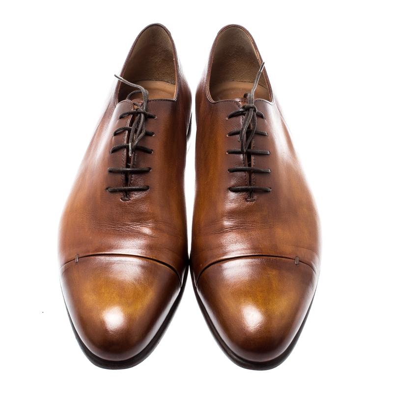 These Oxfords from Berluti are a gentleman's closet asset. Meticulously crafted from leather, they feature lace-up details and a neat Cognac brown shade. Carrying a smooth and seamless silhouette, these Oxfords will complete all your formal
