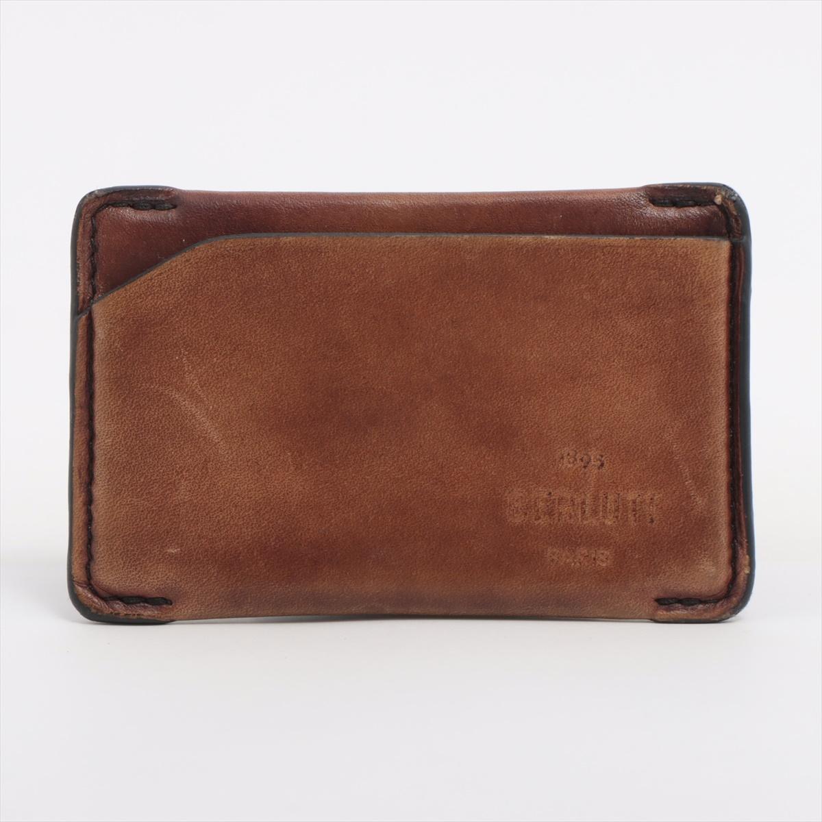The Berluti Logo Leather Card Case in Brown is a refined and minimalist accessory crafted from luxurious Venezia leather, known for its rich patina and artisanal finish. The slim card case features multiple slots for essential cards and is accented
