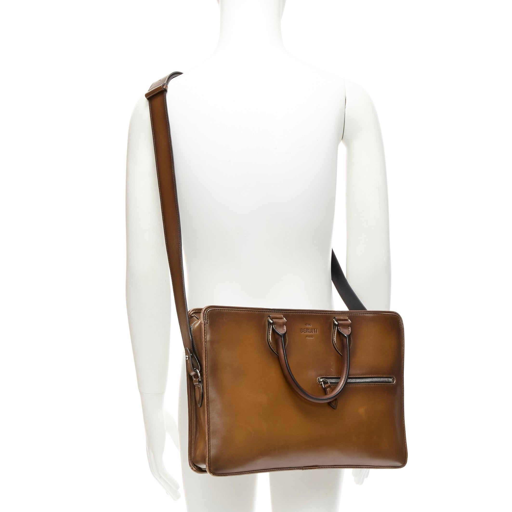 BERLUTI Un Jour brown leather logo zip top handle briefcase
Reference: YIKK/A00053
Brand: Berluti
Model: Un Jour
Material: Leather
Color: Brown, Silver
Pattern: Solid
Closure: Zip
Lining: Beige Fabric
Extra Details: This Berluti briefcase is made in