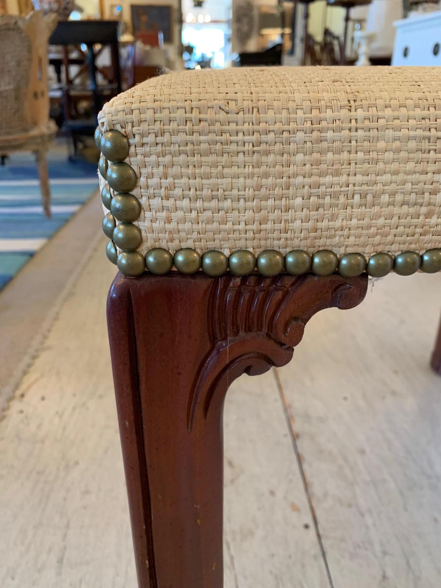 A chic Chippendale inspired raffia wrapped square side table having carved mahogany legs, brass nailhead detailing, and bevelled glass top.