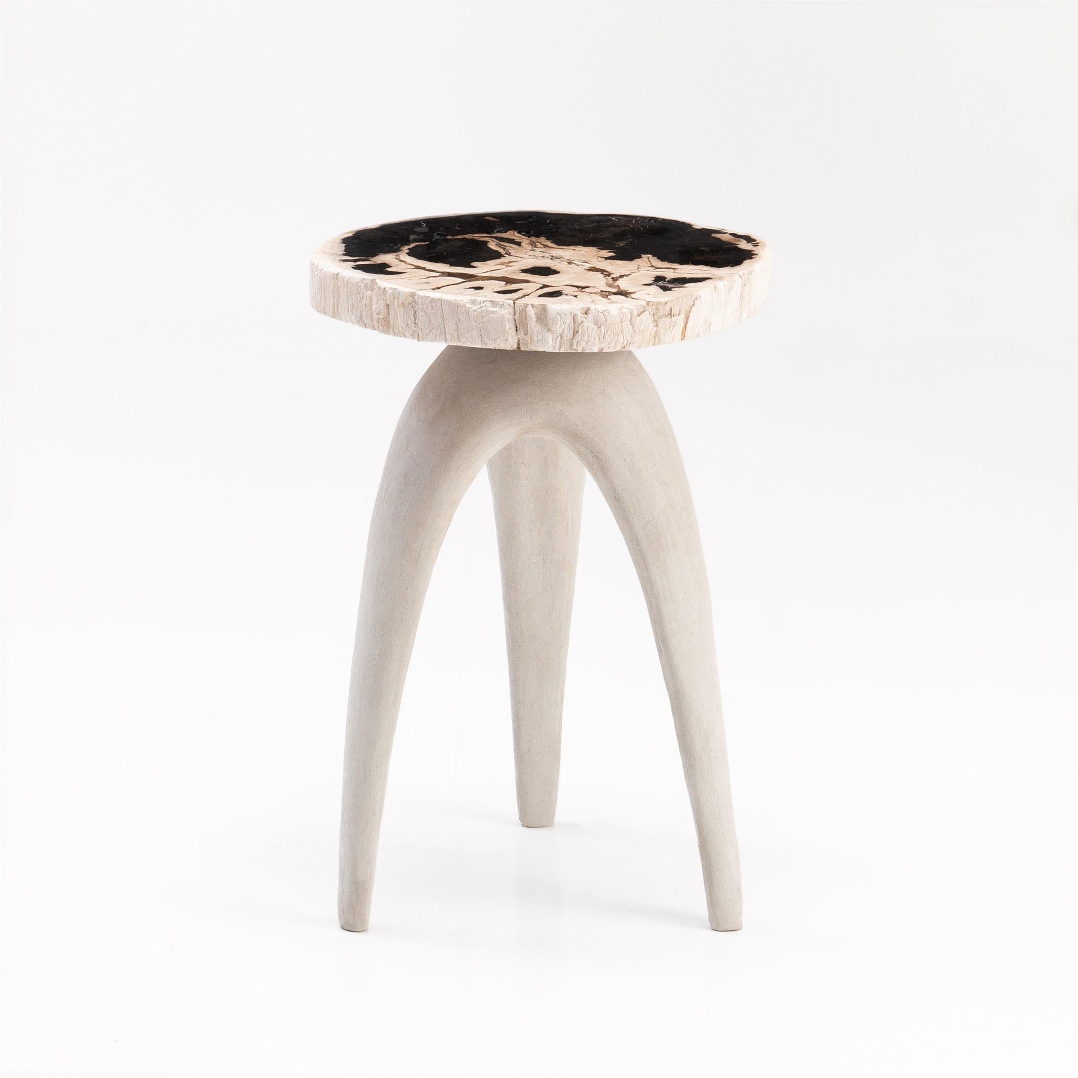 The ‘Bermuda Love Triangle’ sculptural side-table features a solid petrified wood top, perched upon an organic shaped tripod base handmade from limestone composite.

Petrified wood is created from fossilised trees transformed into stone by a