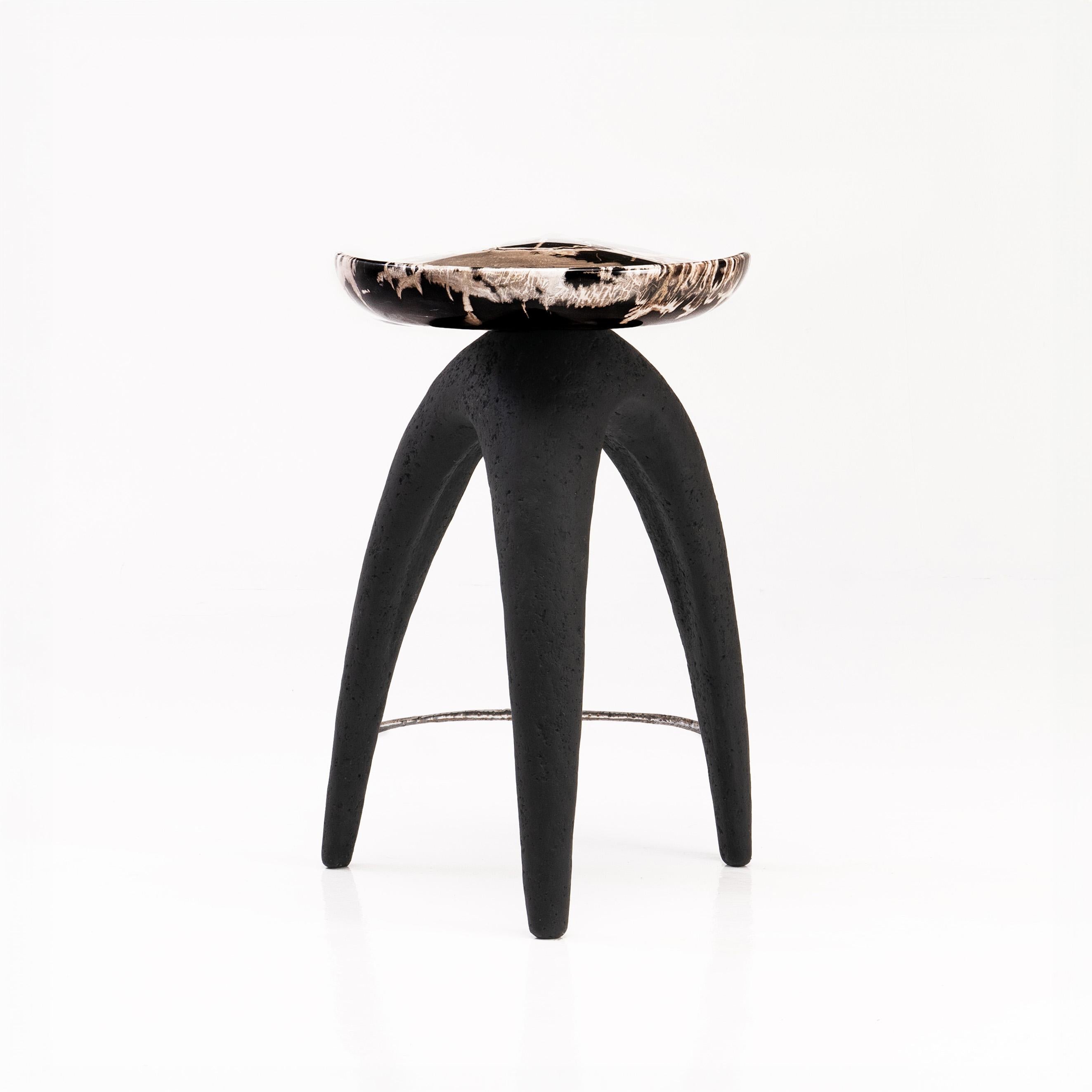 The ‘Bermuda Triangle’ sculptural stool features a solid hand-carved petrified wood saddle seat, perched upon an organic shaped tripod base made from lava stone composite.
 
Petrified wood is created from fossilised trees transformed into stone by a