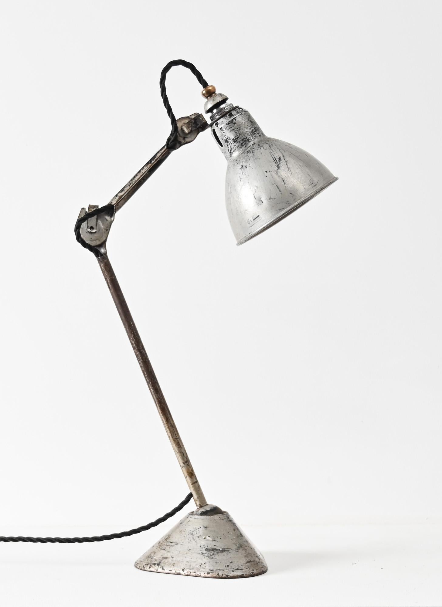 Gras model 205 designed in the 1930s by Bernard Albin Gras. Cast iron base, two adjustable arms and its original reflector. A classic industrial design made popular by Le Corbusier and Henri Matisse, to name a few. This example has been rewired and