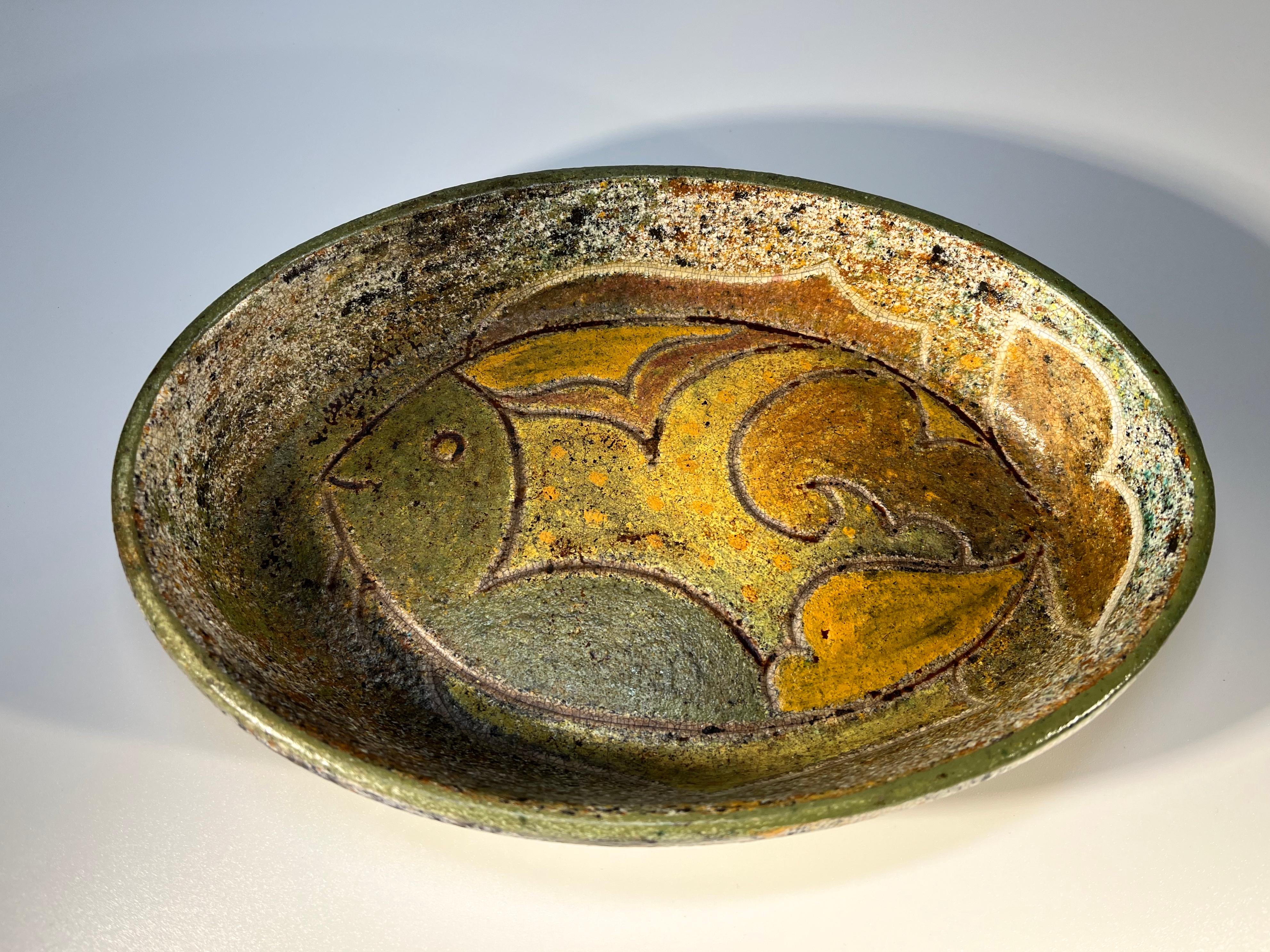 A superb polychromatic glaze  with stylised fish, decorates this oval shaped ceramic dish
Created by renowned ceramicist Bernard Buffat for La Grange Aux Potiers, France
Circa 1970
Signed Piece Unique and initials
Height 1.5 inch, Width 9 inch,