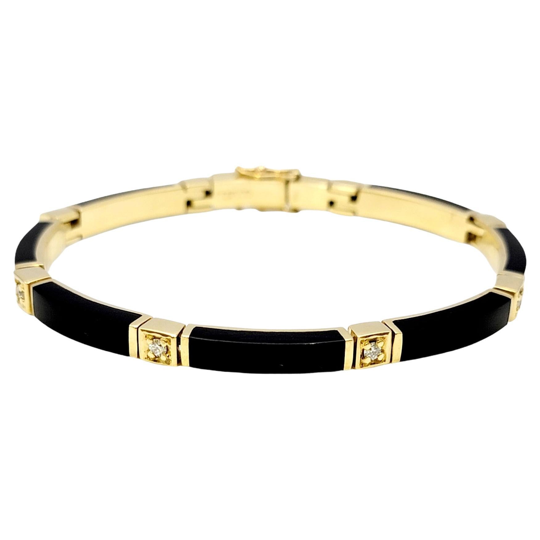 Gorgeous limited edition bracelet by Bernard K. Passman. Sleek and sculptured, this unique black coral bar link bracelet with dazzling diamond accents looks elegant and chic on the wrist. The warm 18 karat yellow gold setting completes this