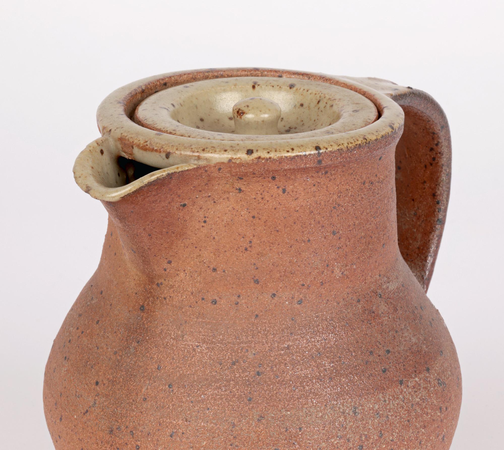 A stylish midcentury ash glazed handcrafted Studio Pottery coffee pot by renowned English potter Bernard Leach CBE (British, 1887-1979) and made at the Leach Pottery in St Ives, Cornwall. The stoneware vase pot stands on a flat narrow round base