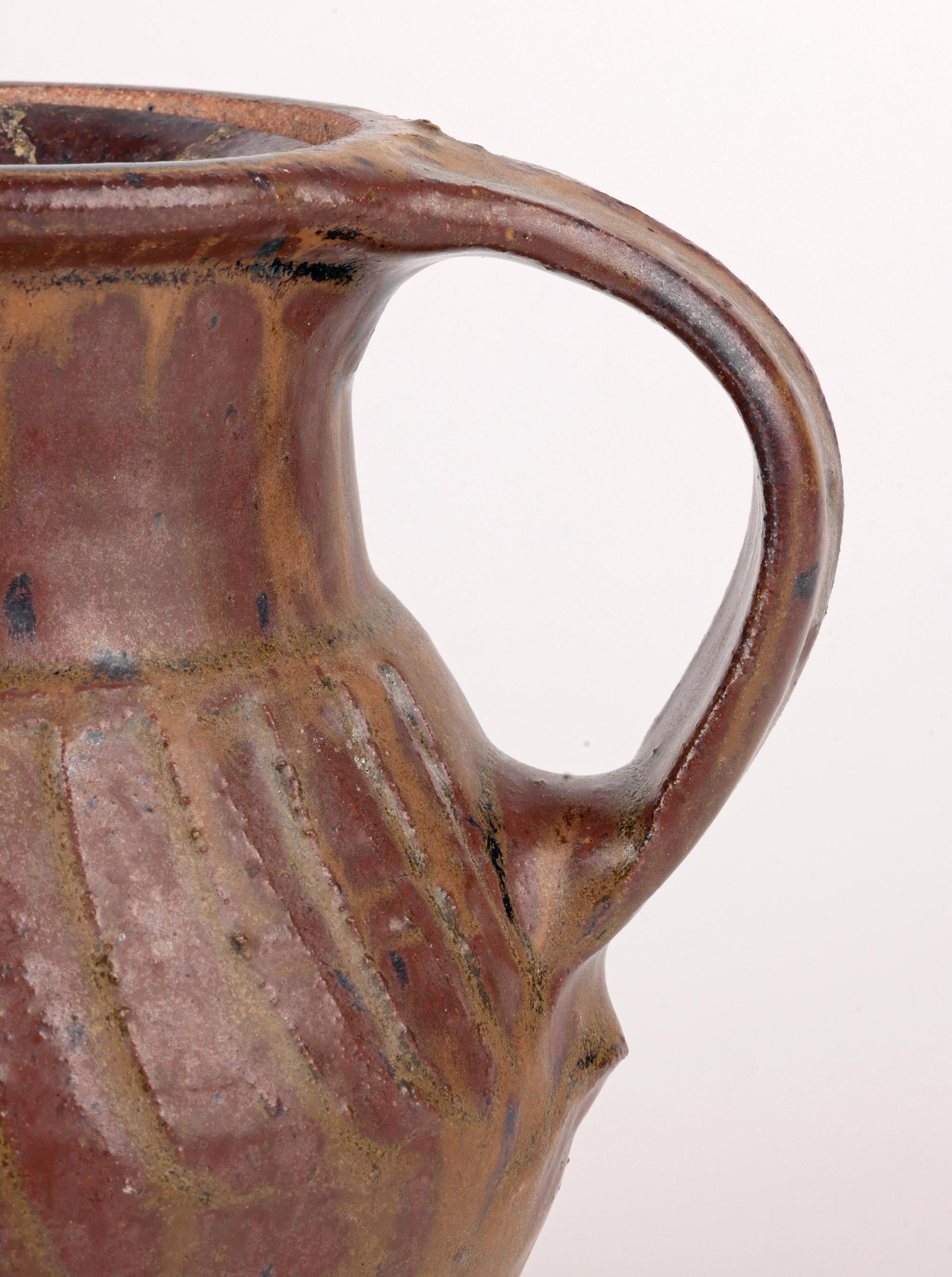 A rare and early tenmoku glazed handcrafted Studio Pottery coffee pot by renowned English potter Bernard Leach CBE (British, 1887-1979) and made at the Leach Pottery in St Ives, Cornwall in the first half of the 20th Century. The stoneware pot
