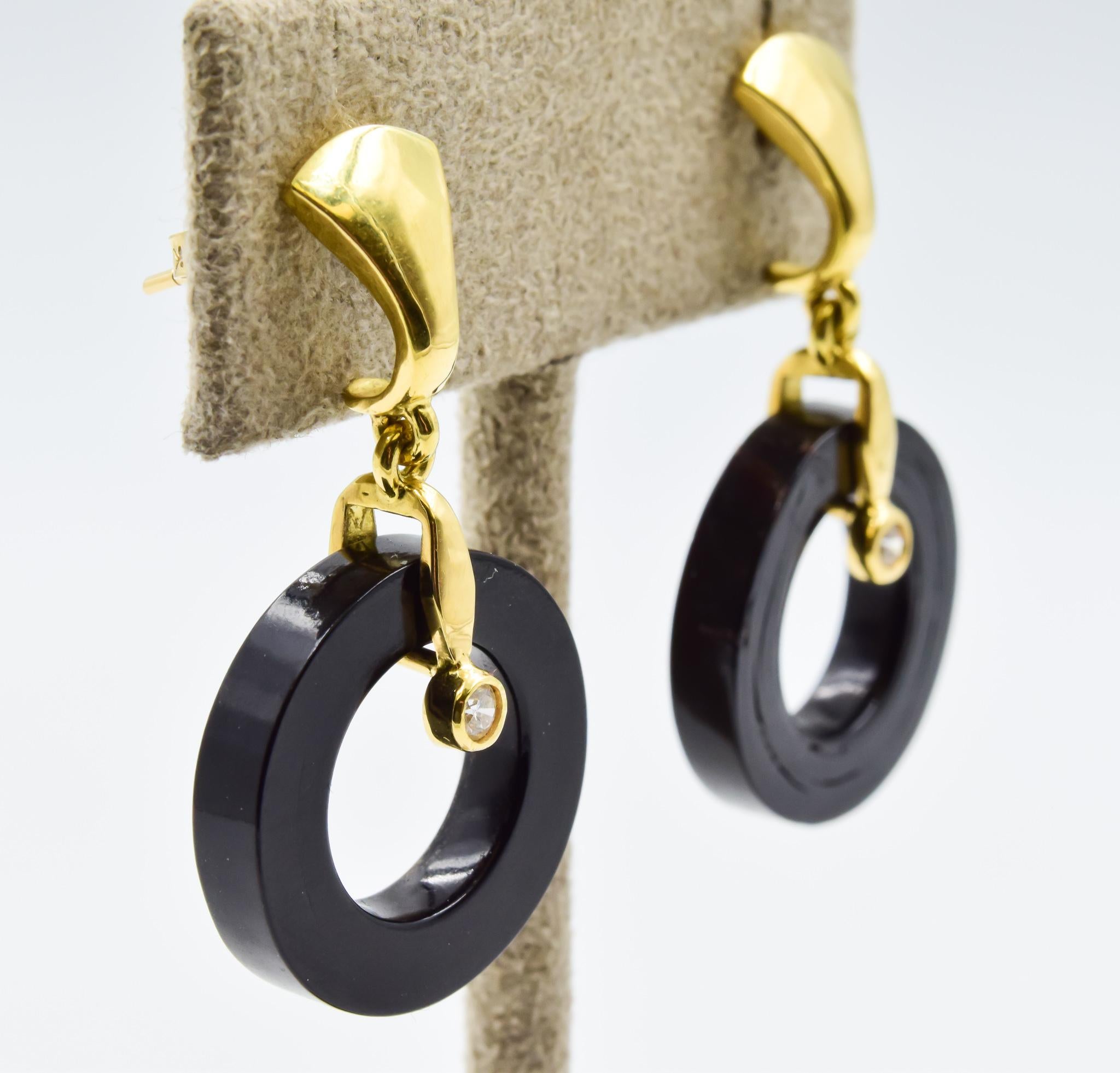These earrings were recently traded in to our store and are in excellent condition! They feature the signature black coral that is used in the Bernard Passman pieces. These are hung on 18 carat gold with a diamond accent feature. The texture of the