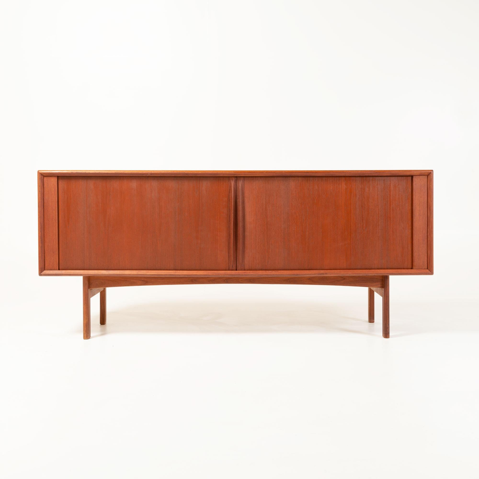A classic Mid-Century Modern Danish Credenza with Tambour door, manufactured by Bernhard Pedersen & Son. In great vintage condition and has been recently restored.
    