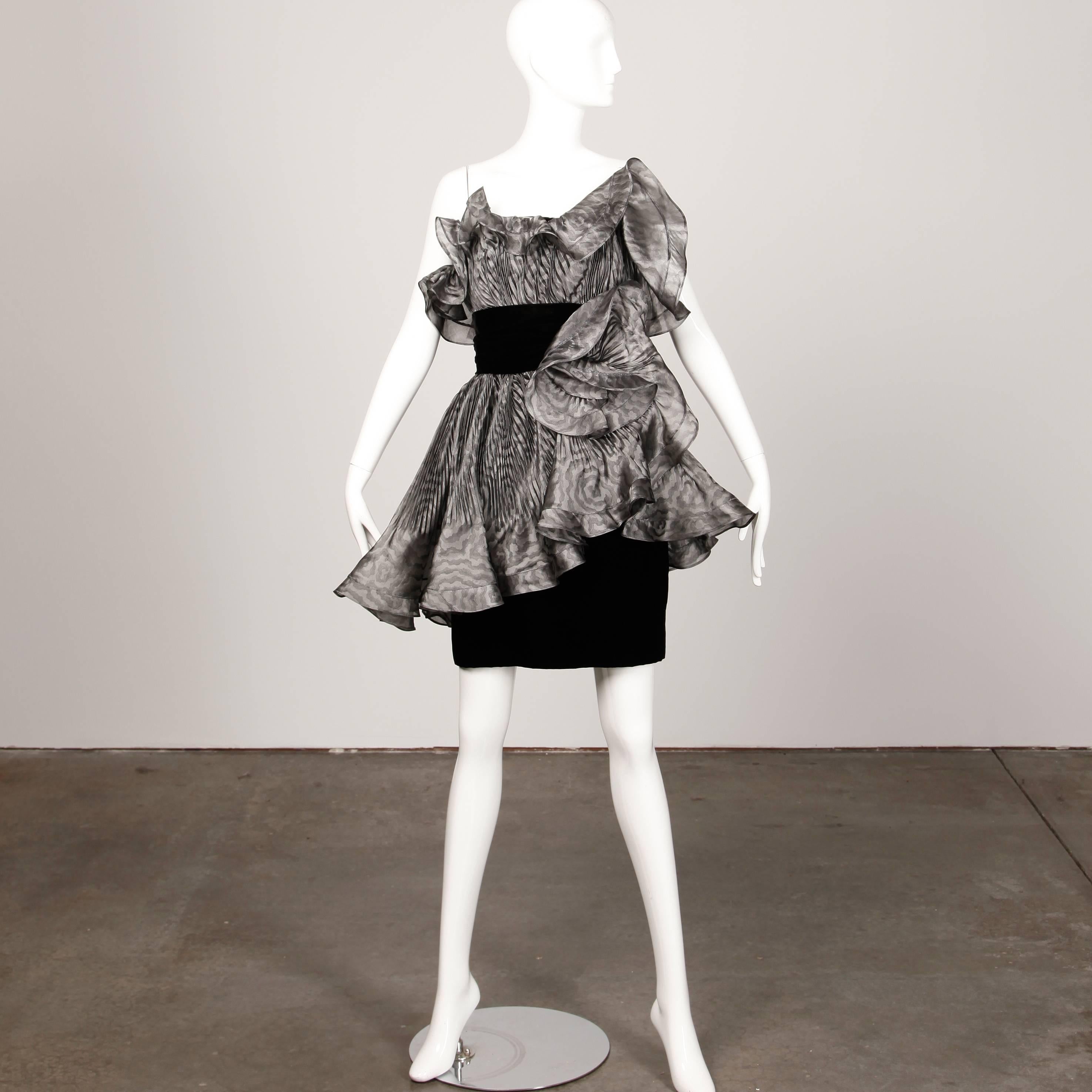 Absolutely incredible vintage Bernard Perris dress with sculptural origami pleating and avant garde shape. One shoulder cut with gray pleated organza and black velvet. Fully lined with side zip, hook and snap closure. The construction on this dress