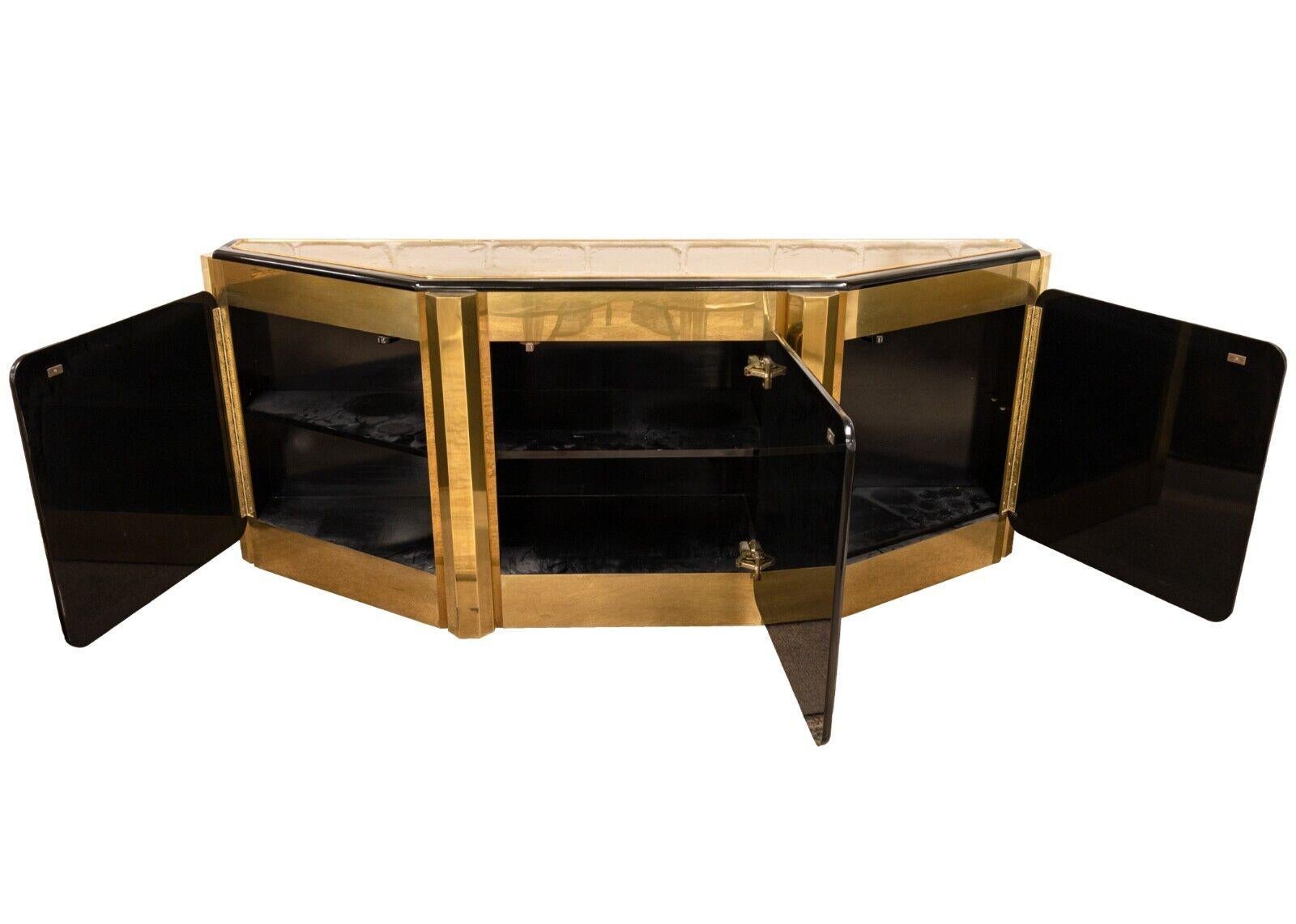 A Bernard Rhone acid etched tree of life credenza for Mastercraft. This gorgeous credenza is a real statement piece. Its bold use of brass construction and deep black accents make for a shining piece of furniture. This piece also prominently