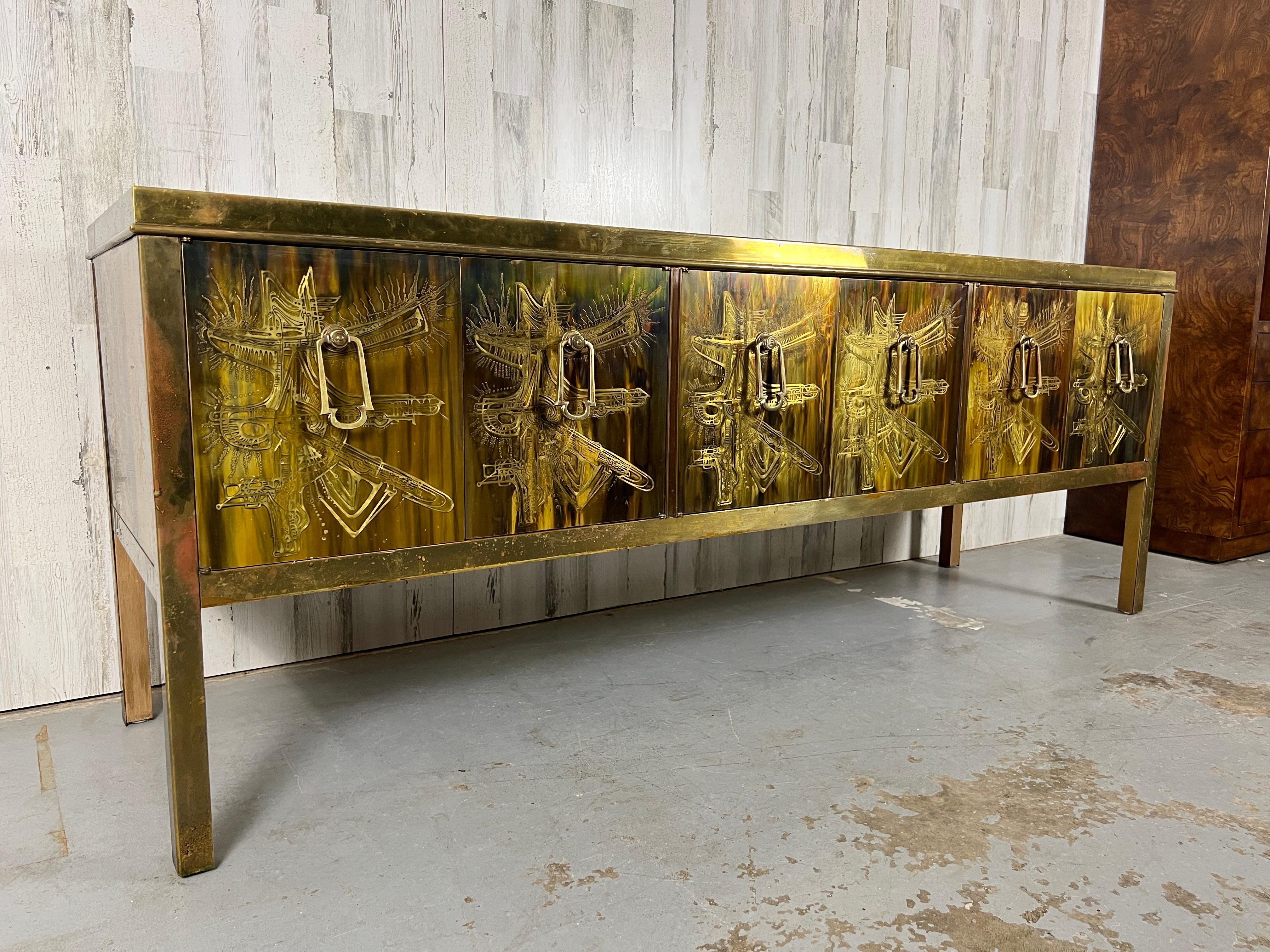 Bernhard Rohne for Mastercraft. six-door acid etched and embossed brass credenza with brass pulls housed in a brass frame with a nice patina . Designed by Bernhard Rohne for Mastercraft.