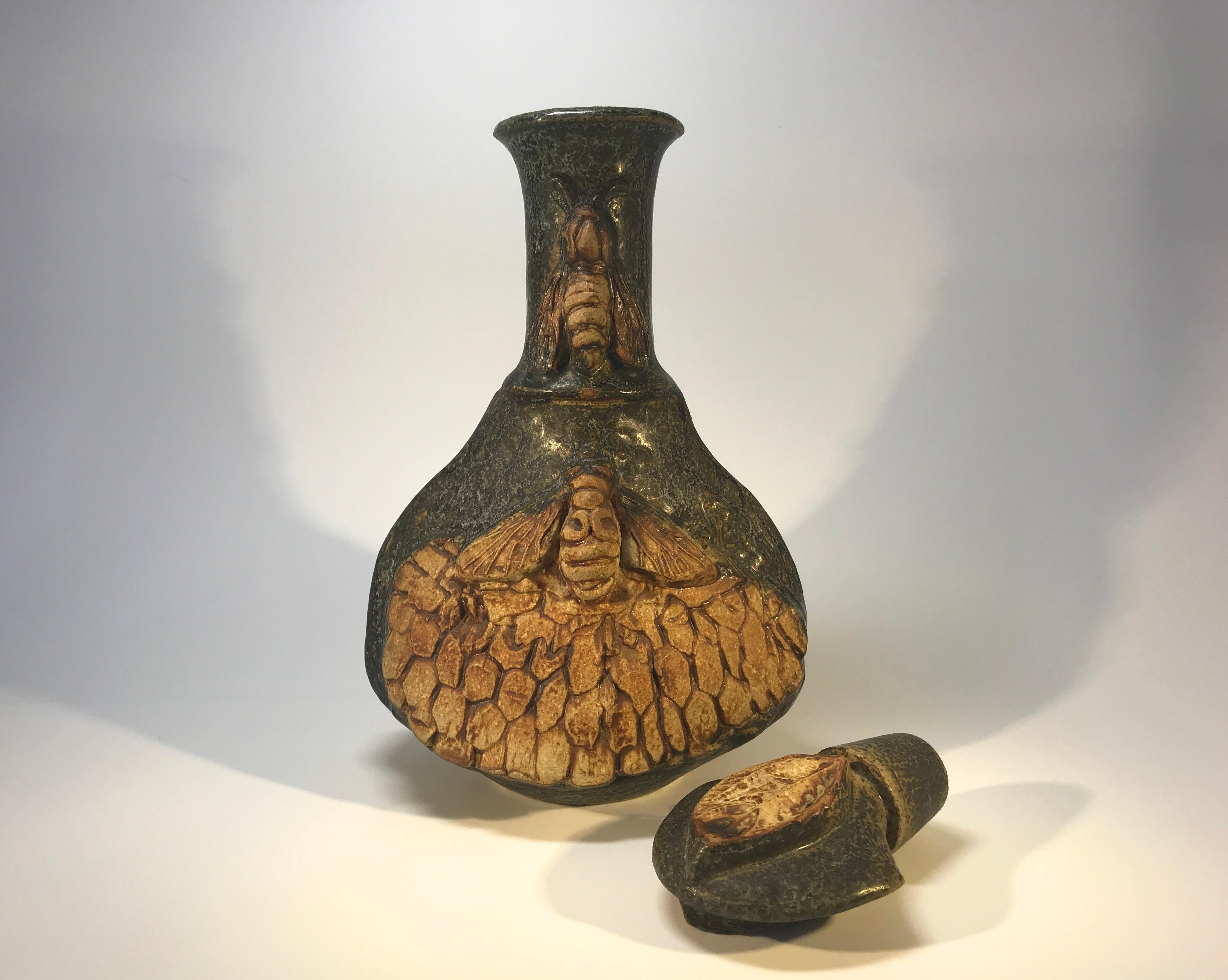 Hand formed by Bernard Rooke of England, stoneware decanter decorated with hand formed honeycomb and bees to both front and back
A super example of Rooke's creativeness and a worthy collectors piece
Signed BR
Measures: Height including stopper