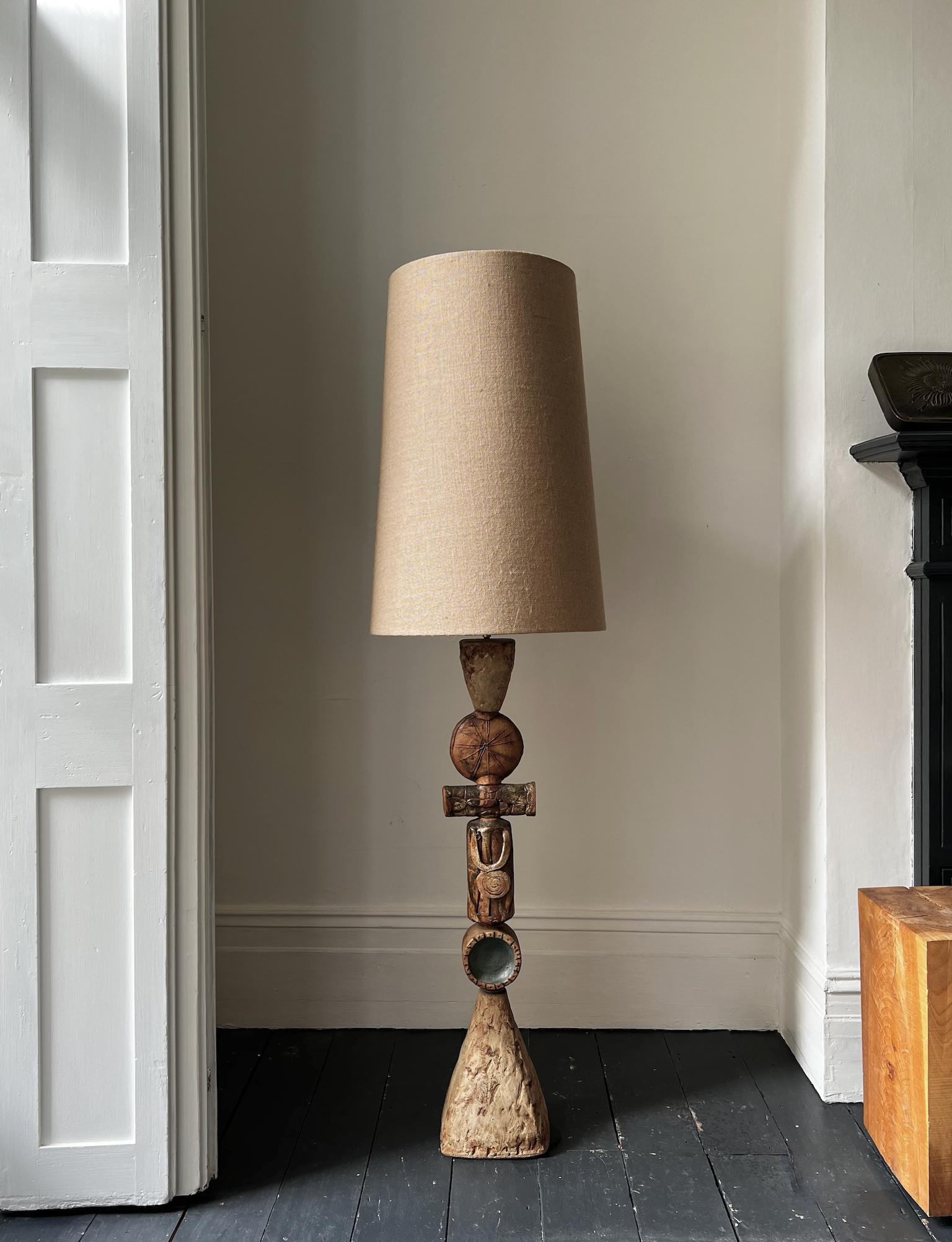 A mid-20th century totem lamp by ceramicist Bernard Rooke, England. 

An early piece, and unusual to see this example of Rooke's work; hand-built, with great character in natural shades of brown, terracotta, light oatmeal and grey. A tall piece for