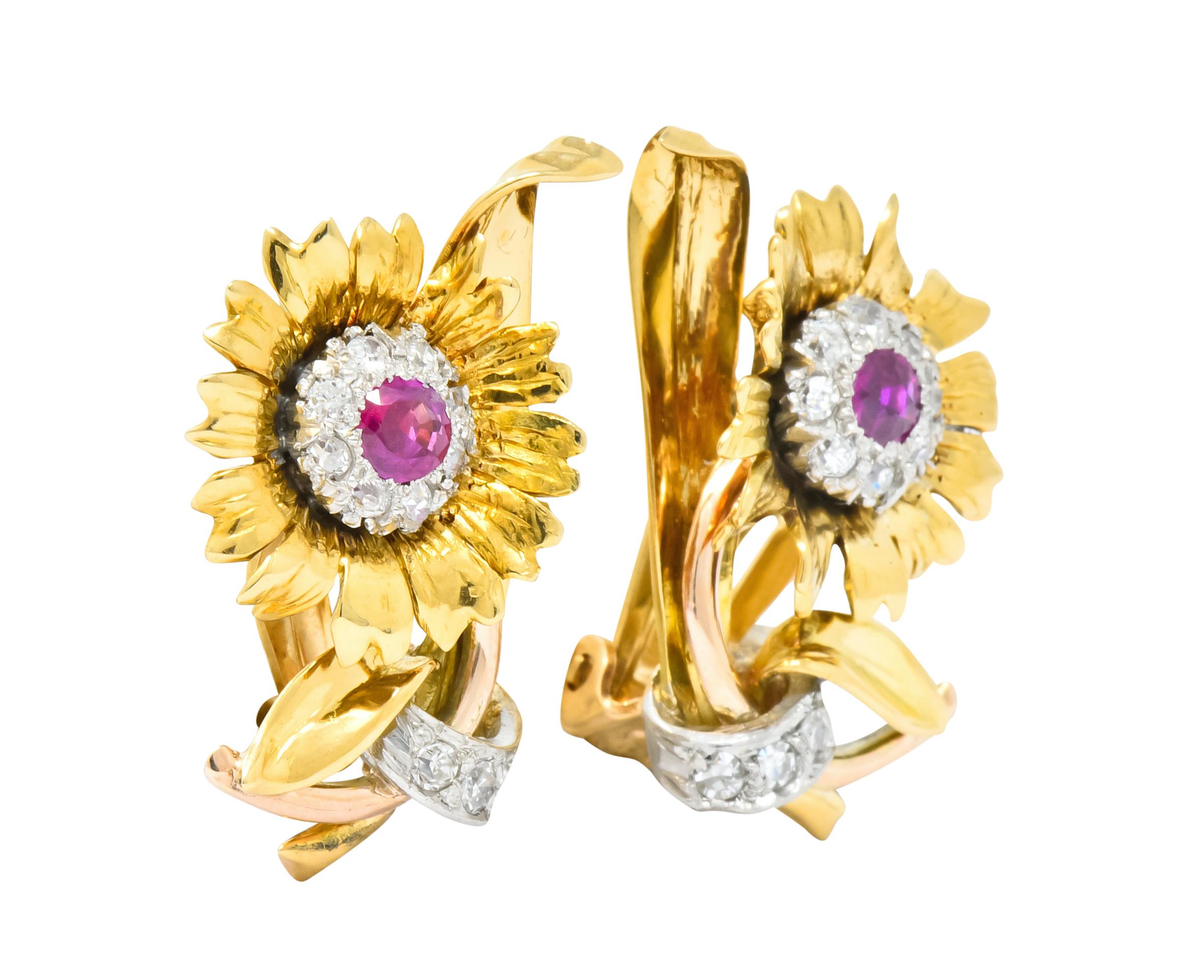 Each earring designed as a flower with radiating petals, stem, and scrolling foliate

Centering round cut rubies weighing approximately 0.60 carat total, semi-transparent and vividly red in color

Surrounded by old European cut diamonds, bead set in