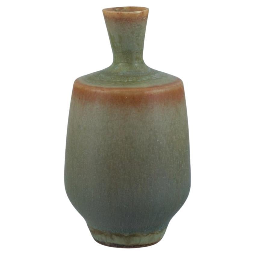 Berndt Friberg for Gustavsberg. Miniature vase with glaze in shades of green