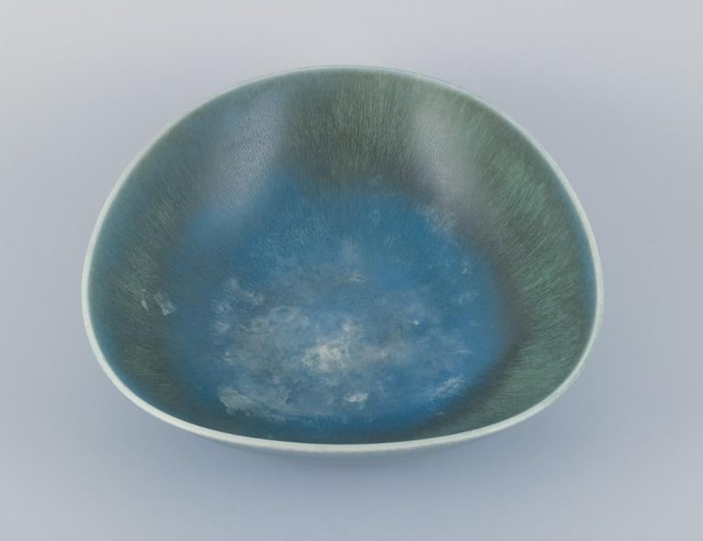 Berndt Friberg for Gustavsberg, Sweden.
Large ceramic bowl with glaze in blue-green tones.
Dated 1964.
Perfect condition.
Signed.
Dimensions: D 32.0 cm x H 9.5 cm.