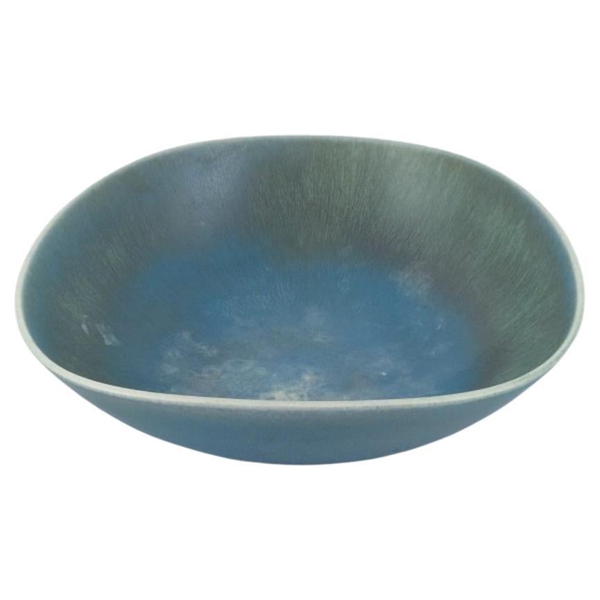 Berndt Friberg for Gustavsberg, Sweden. Large ceramic bowl in blue-green tones