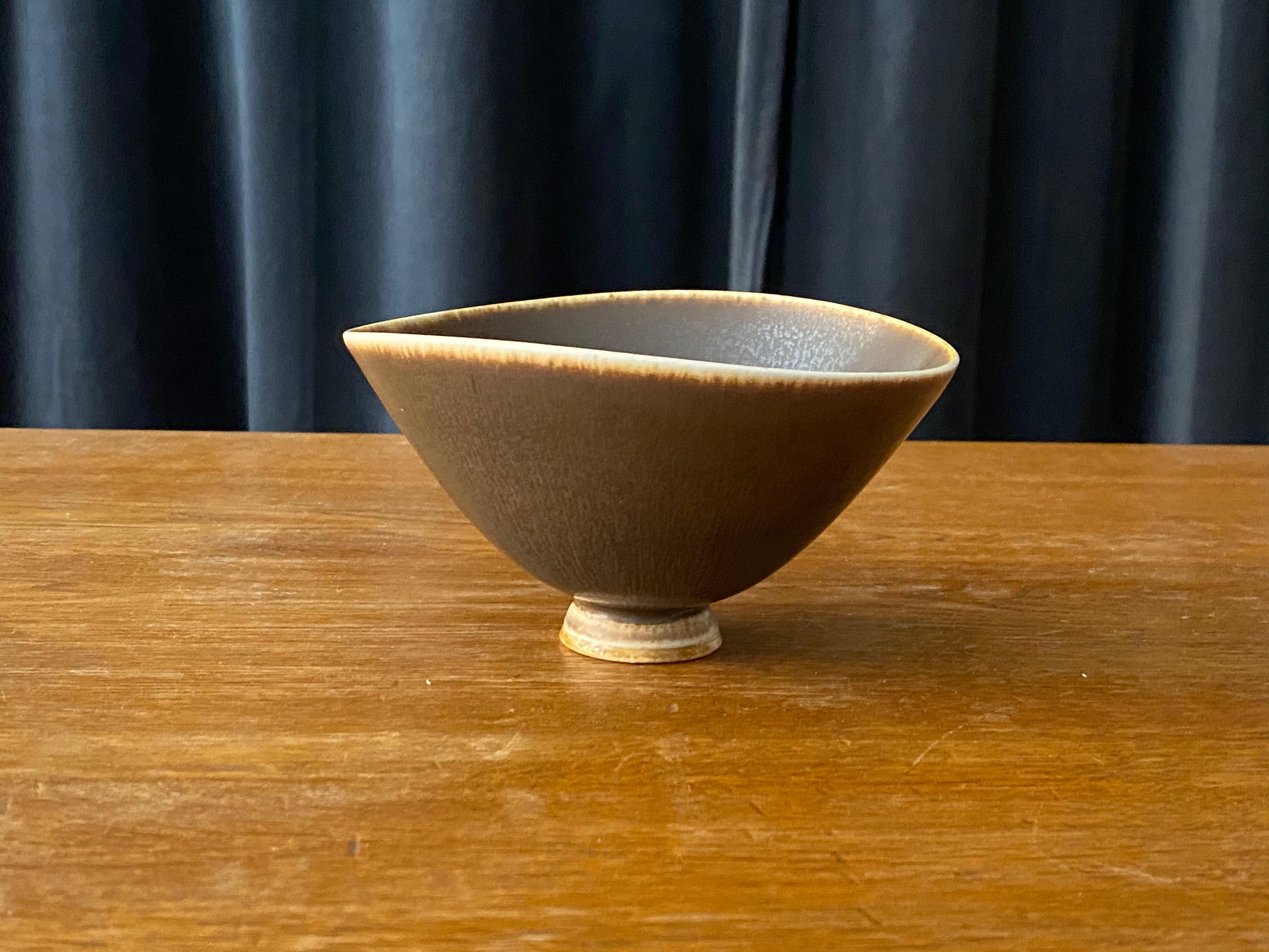 An organicly shaped ceramic stoneware bowl by Berndt Friberg for the iconic Swedish pottery firm Gustavsberg. Signed and dated 1976.

Other ceramicists of the period include Berndt Friberg, Axel Salto, and Wilhelm Kåge.