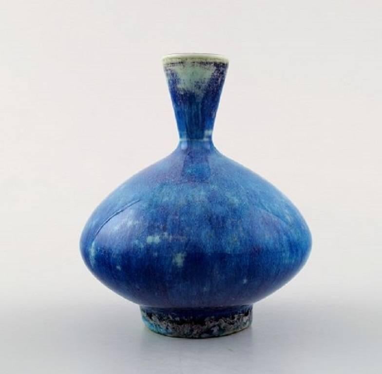 Berndt Friberg studio ceramic vase. Modern Swedish design. Unique, handmade. Rare form.
Fantastic glaze in blue tones.
Perfect condition. 1st. assortment.
Measures: 8 cm x 7 cm.
Signed.