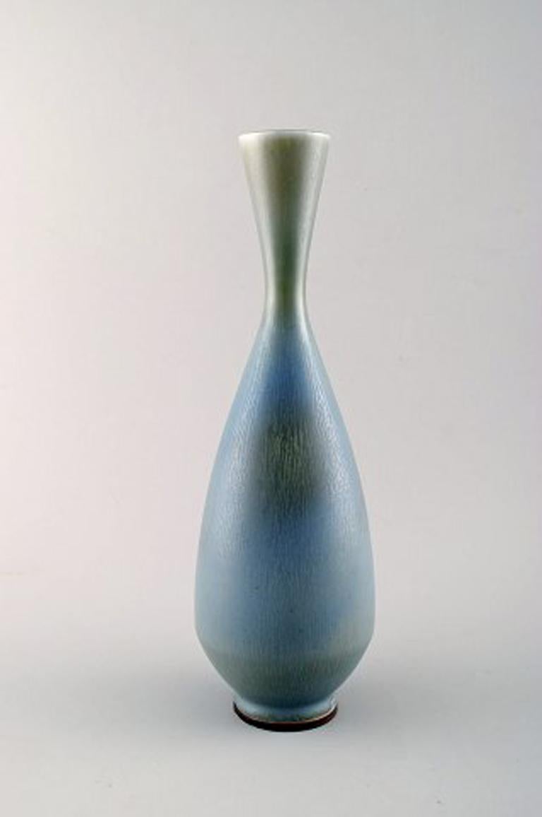 Berndt Friberg Studio large ceramic vase. Modern Swedish design. Unique, handmade.
Stamped.
Fantastic glaze in blue/green tones.
Perfect condition. 1st factory quality.
Measures: 32.5 cm. x 11 cm.