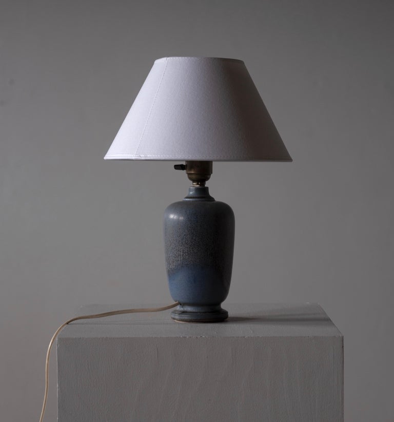 A rare table lamp by Berndt Friberg. Features blue glazed stoneware. In a 