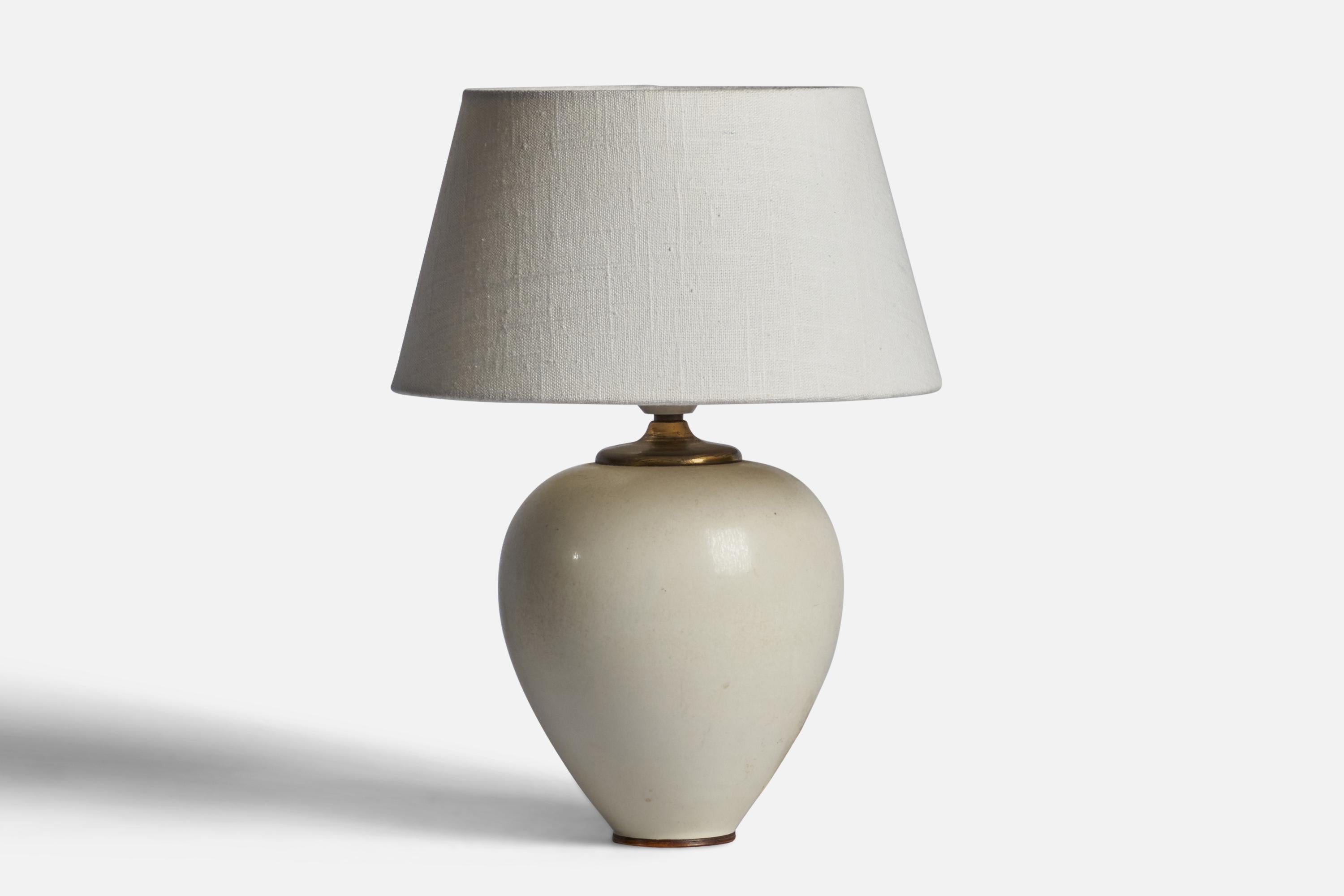 An off-white glazed stoneware and brass table lamp designed by Berndt Friberg and produced by Gustavsberg, Sweden, 1950s.

Dimensions of Lamp (inches): 10.5” H x 6.25” Diameter
Dimensions of Shade (inches): 7” Top Diameter x 10” Bottom Diameter x