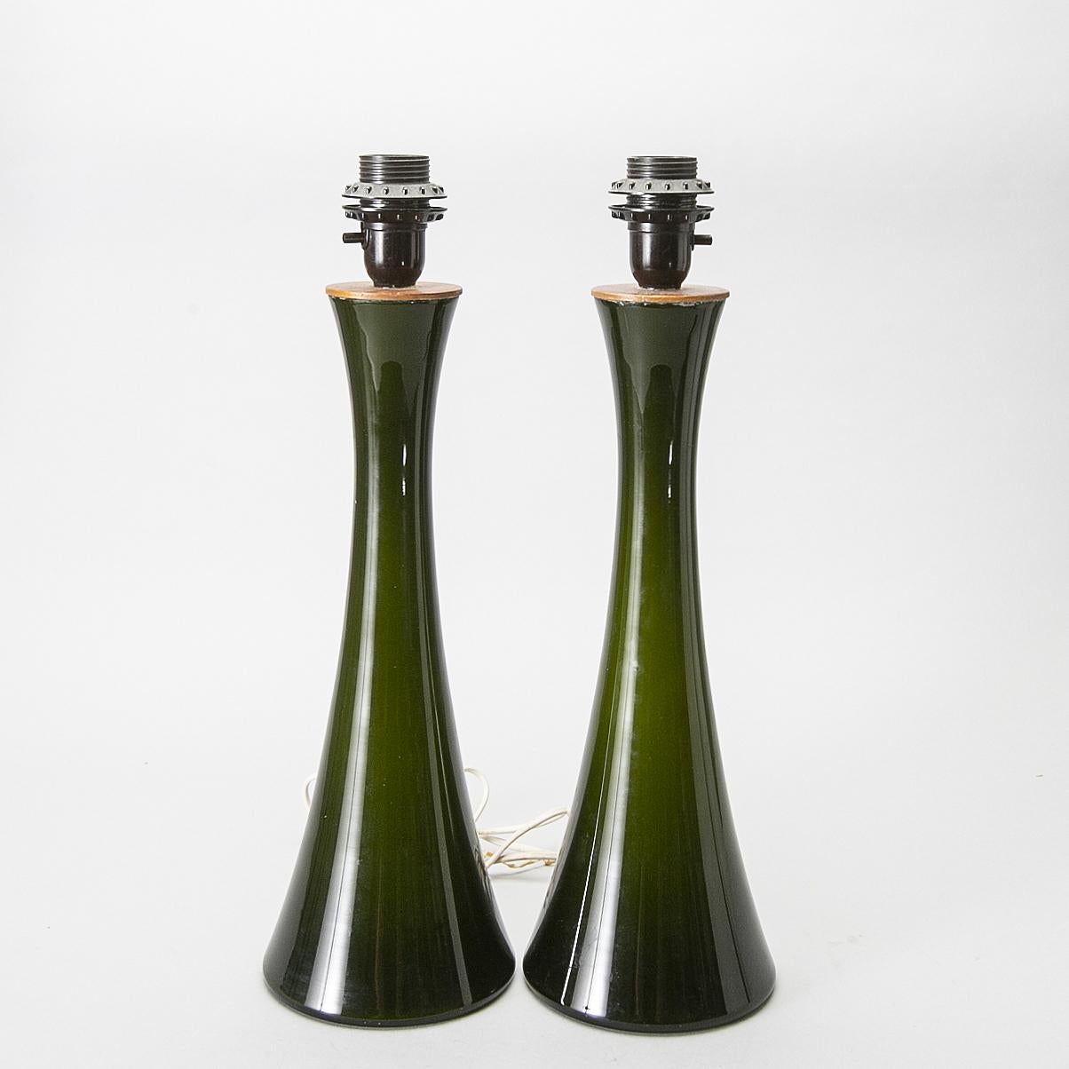 Berndt Nordstedt, pair of glass lamp, Bergboms, 1970 midcentury

Swedish lamps
Green tinted glass with teak details.
Measures: Socket height 40 cm
Height with shade 62cm
Bottom diameter 14cm
Label marked.

Shades are included 

  