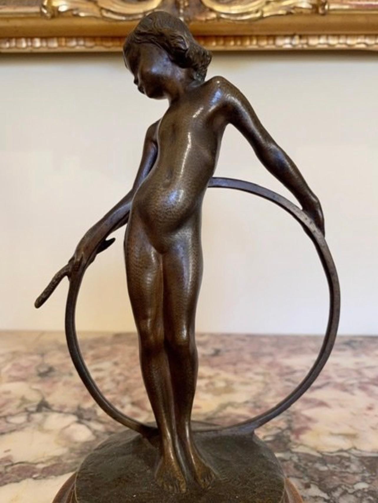 Bronze statuette representing a young girl with a hoop signed on the base 