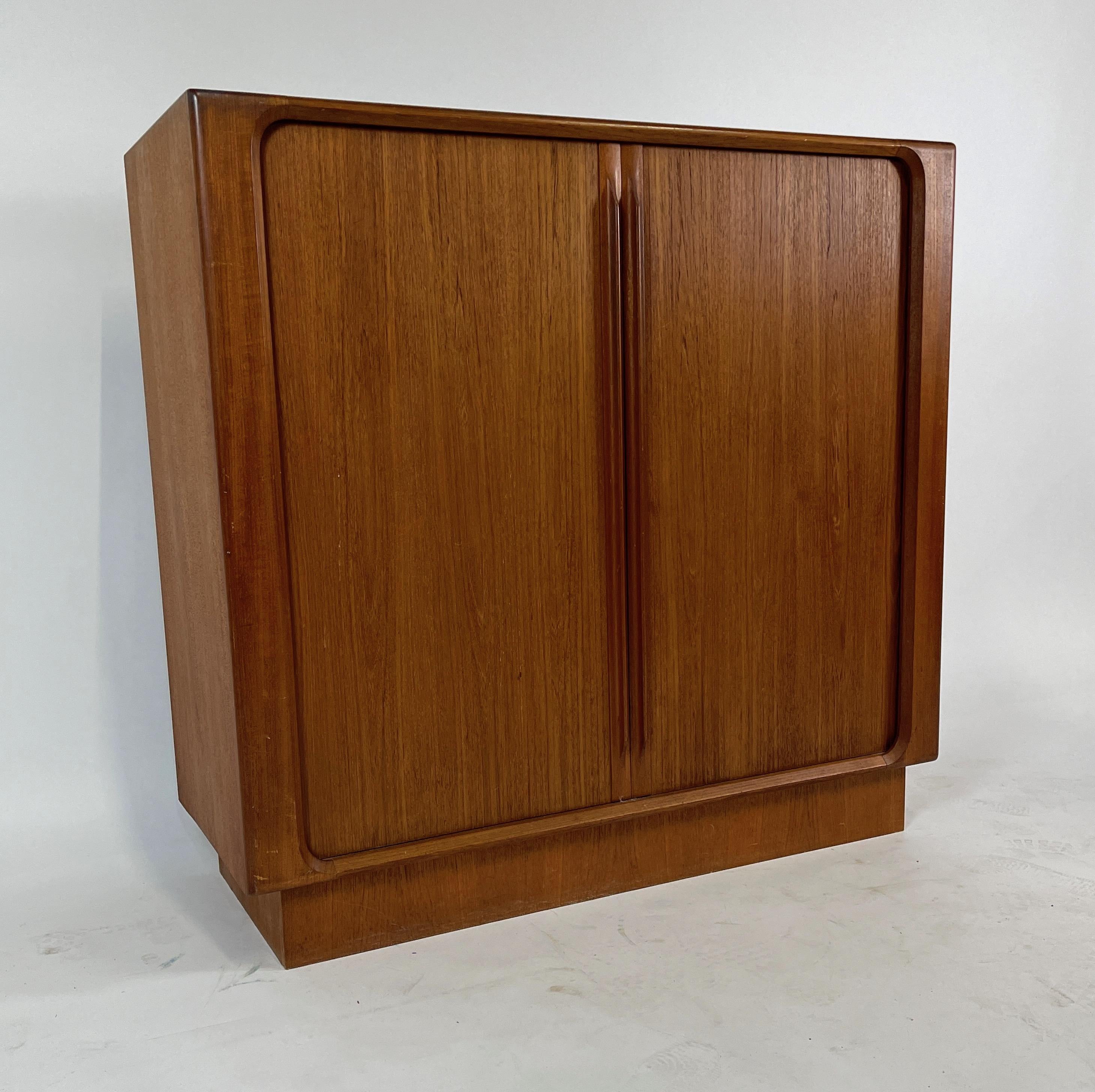 Tall Danish storage piece with ample storage hidden behind very smooth tambour doors. This piece is absolutely stunning in person!
The back is also finished nicely.