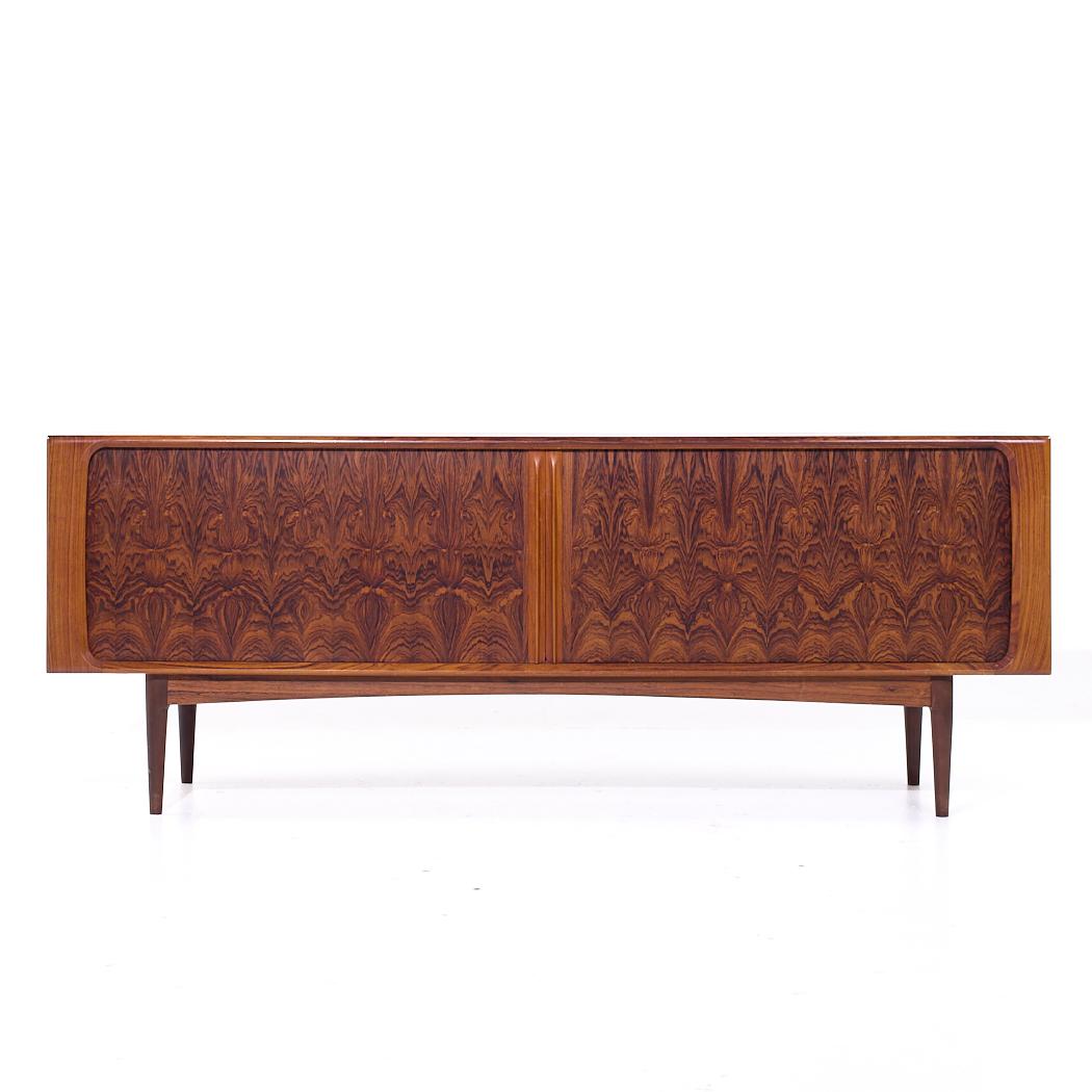 Bernhard Pedersen Mid Century Danish Rosewood Tambour Door Credenza

This credenza measures: 82.75 wide x 19.75 deep x 31.5 inches high

All pieces of furniture can be had in what we call restored vintage condition. That means the piece is restored