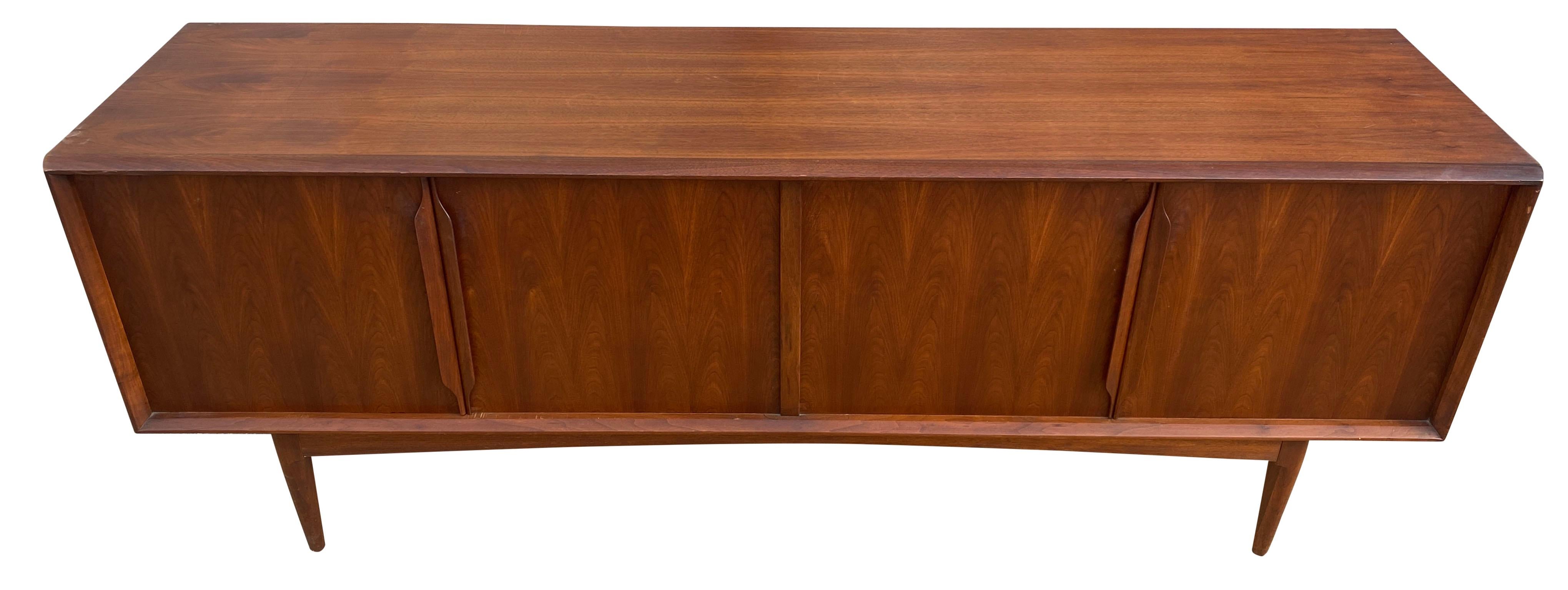Stunning Bernhard Pedersen & Son midcentury long low Danish teak credenza sideboard with 4 doors and 3 drawers also has 3 adjustable shelves. High quality teak wood credenza with sculpted teak handles. Very clean midcentury Danish sideboard. Great