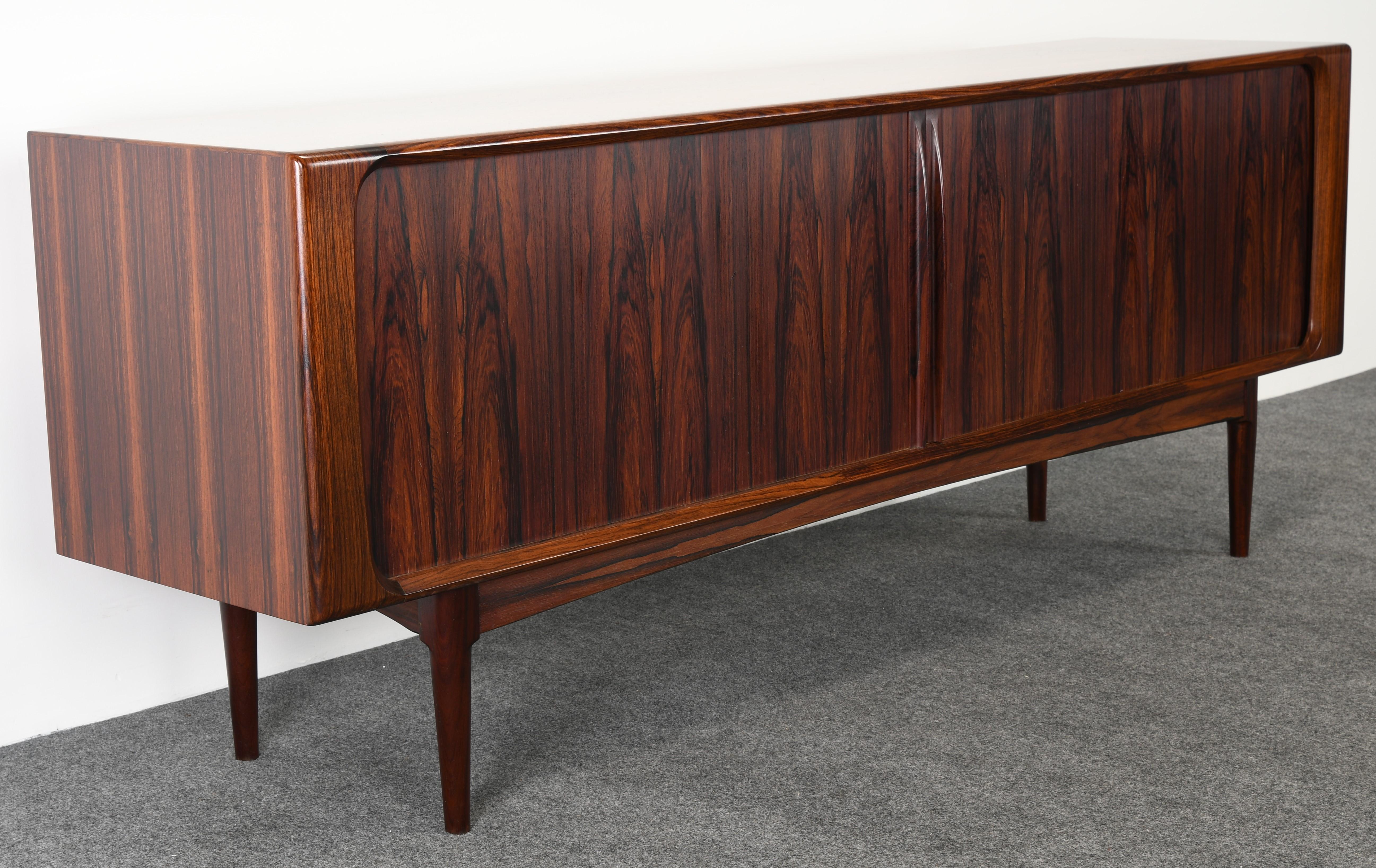 A Danish rosewood credenza or sideboard by Bernhard Pedersen & Son. The cabinet has beautiful graining throughout and is in very good condition. This is one of the best examples we have sold. The backside is finished in Rosewood and can be used in