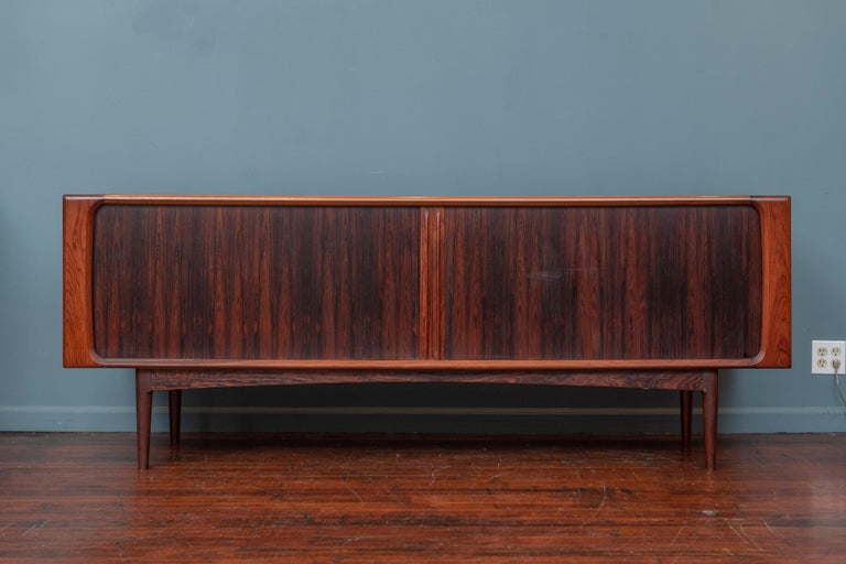 Bernhard Pedersen & Son rosewood credenza, Denmark. Featuring the desirable tambour doors with fully adjustable interior shelves and drawers that is easily converted into a media cabinet if desired. Made from high quality construction and materials