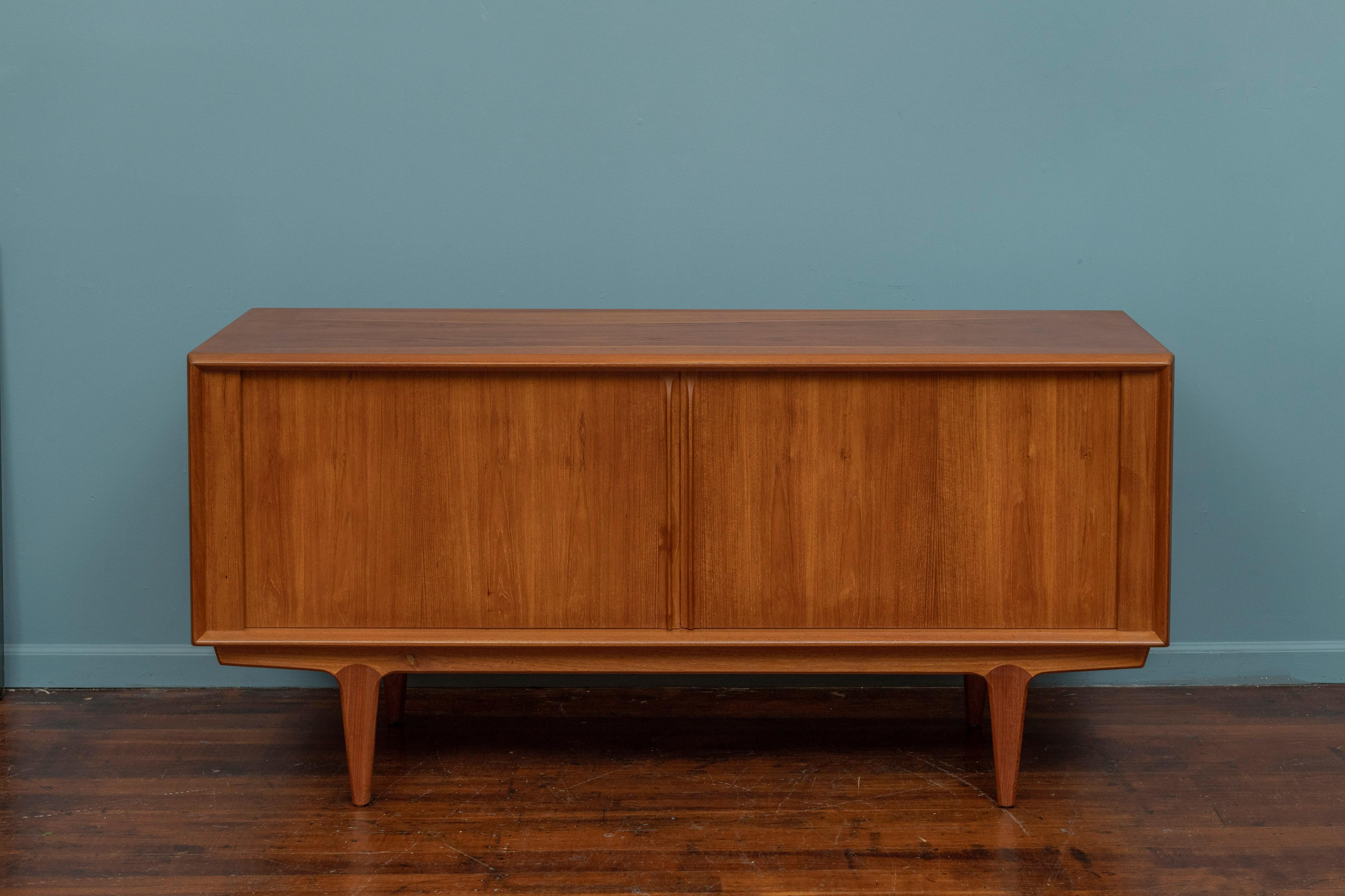 Scandinavian Modern teak credenza by Bernhard Pedersen & Son, Denmark. High quality construction and materials in teak featuring a tambour door and fitted interior. In the seldom seen rare smaller size that is ideal for apartments. or family rooms.