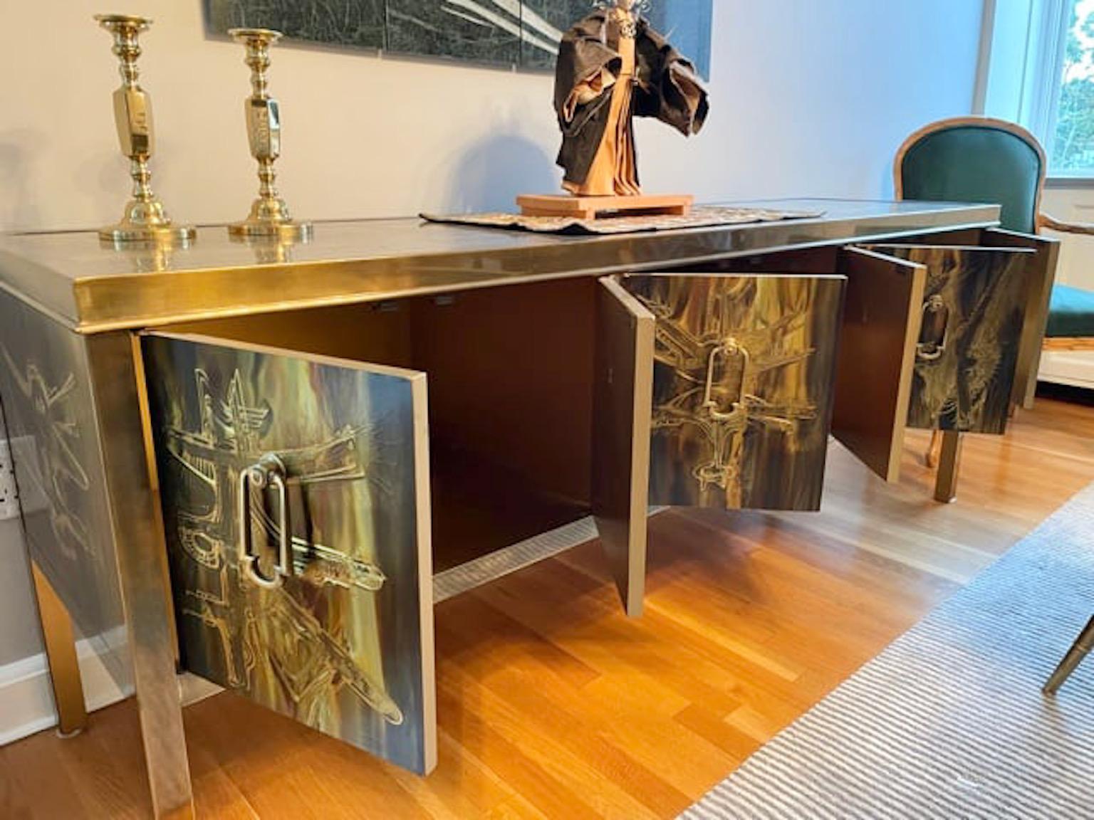 Sophisticated artistic metal craft sideboard credenza by Bernard Rohne for Mastercraft circa 1974 with a most beautiful patina reminiscent of the work of Philip & Kelvin Laverne. Patinated brass trim and legs purposely frame Rohne's art. Six doors