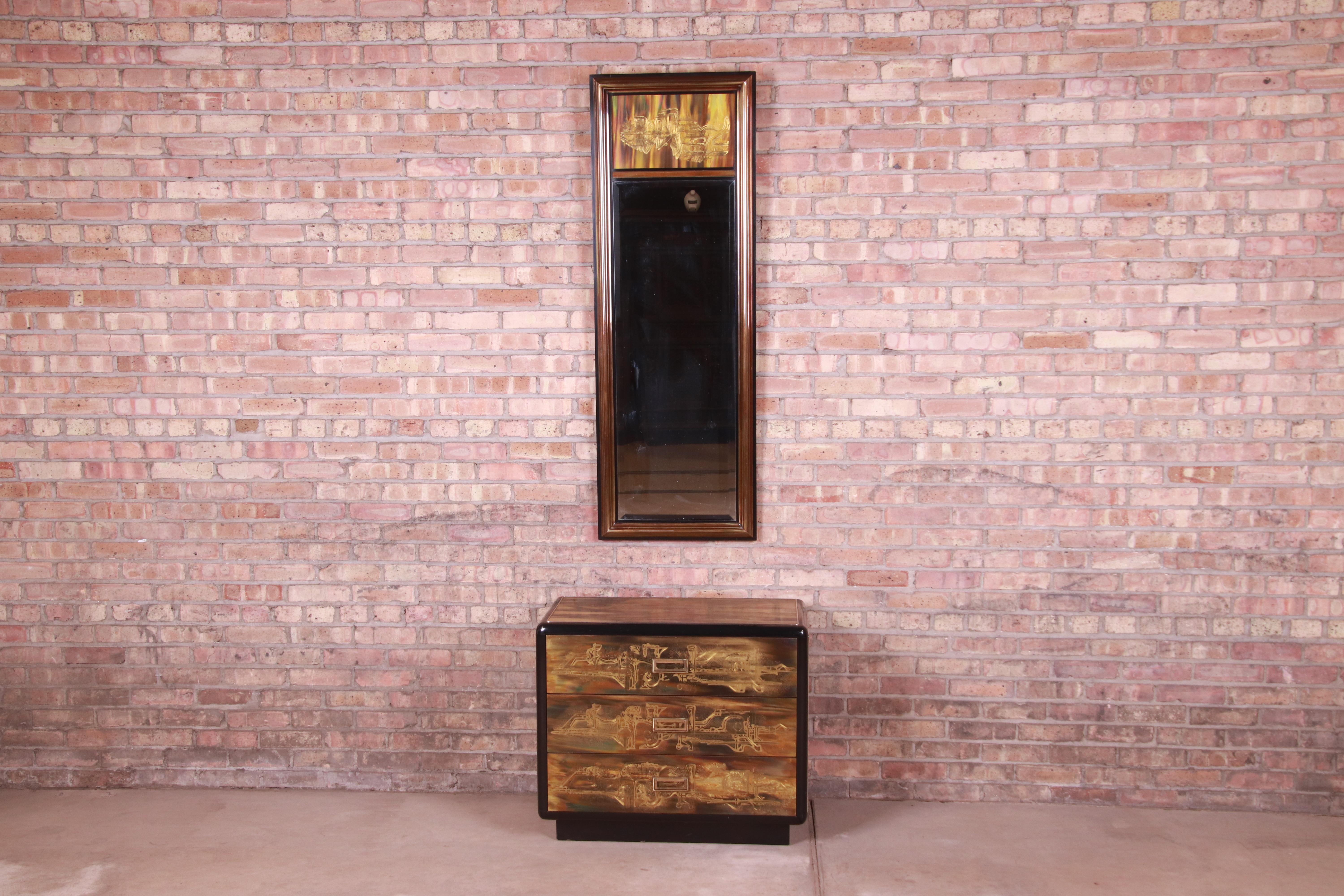 A gorgeous Mid-Century Modern Hollywood Regency chest of drawers with matching wall mirror

By Bernhard Rohne for Mastercraft Furniture

USA, 1970s

Acid etched brass, with black lacquered trim, and original brass hardware.

Chest measures: