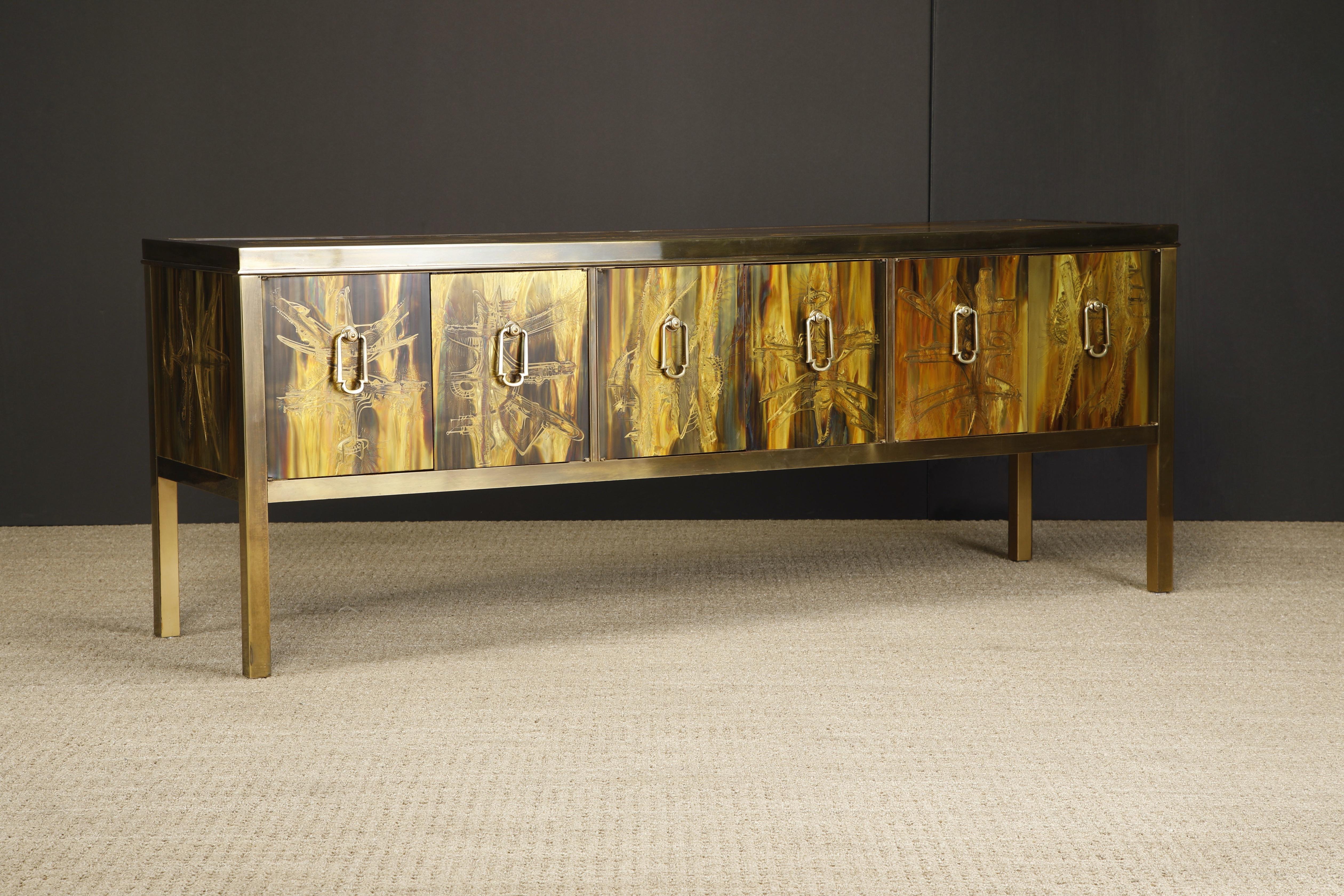 This mesmerizing acid etched brass console cabinet was designed by Bernhard Rohne and produced by Mastercraft in the 1970s. Exquisite acid-etched artwork on the top, sides and front door panels with patinated brass trim and legs. Six doors and door