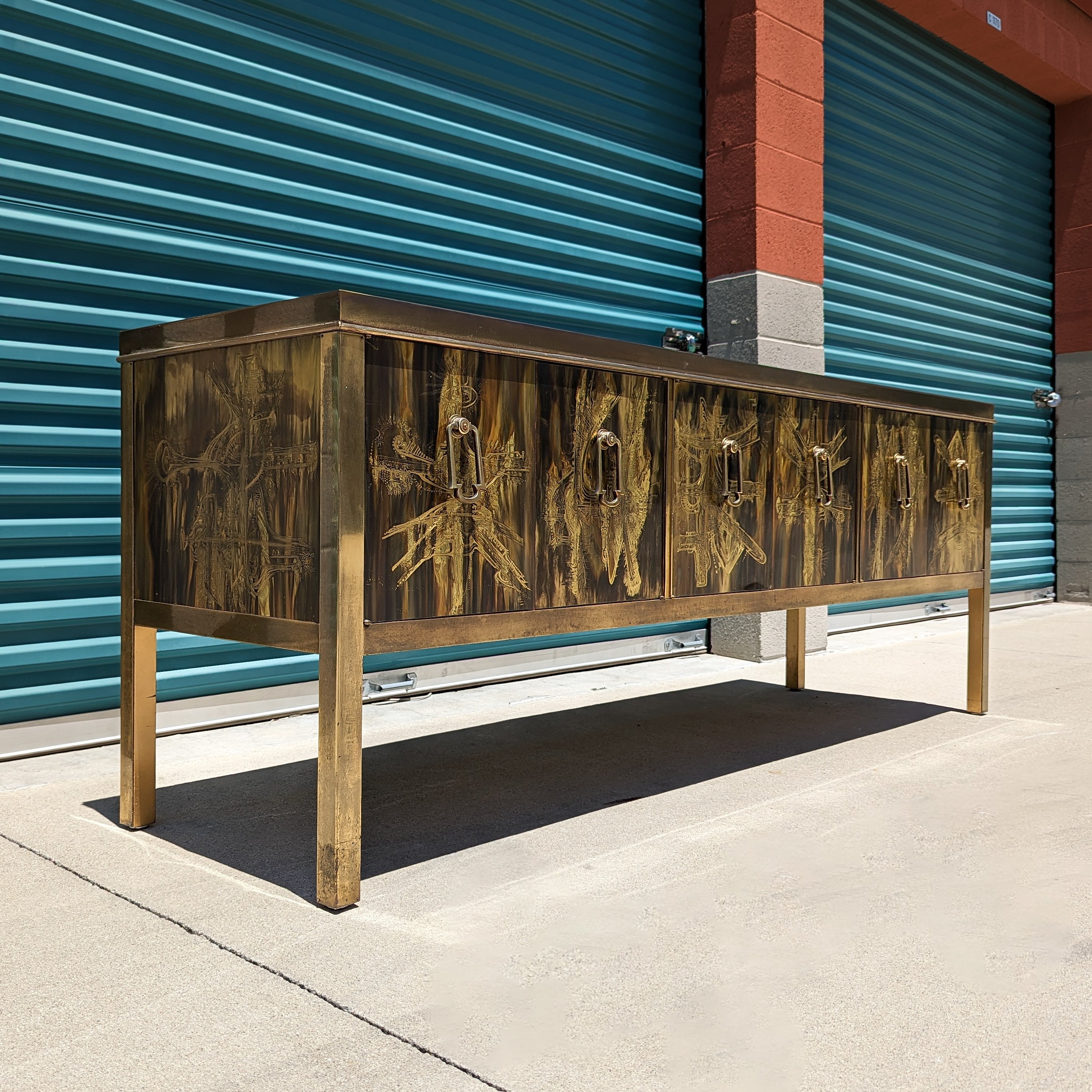 Just in, a spectacular piece designed by Bernhard Rohne for Mastercraft, c1970s sourced from original owners from the Hollywood Hills. This credenza features a brass finish with intricate etched designs throughout - top, sides, legs, and door