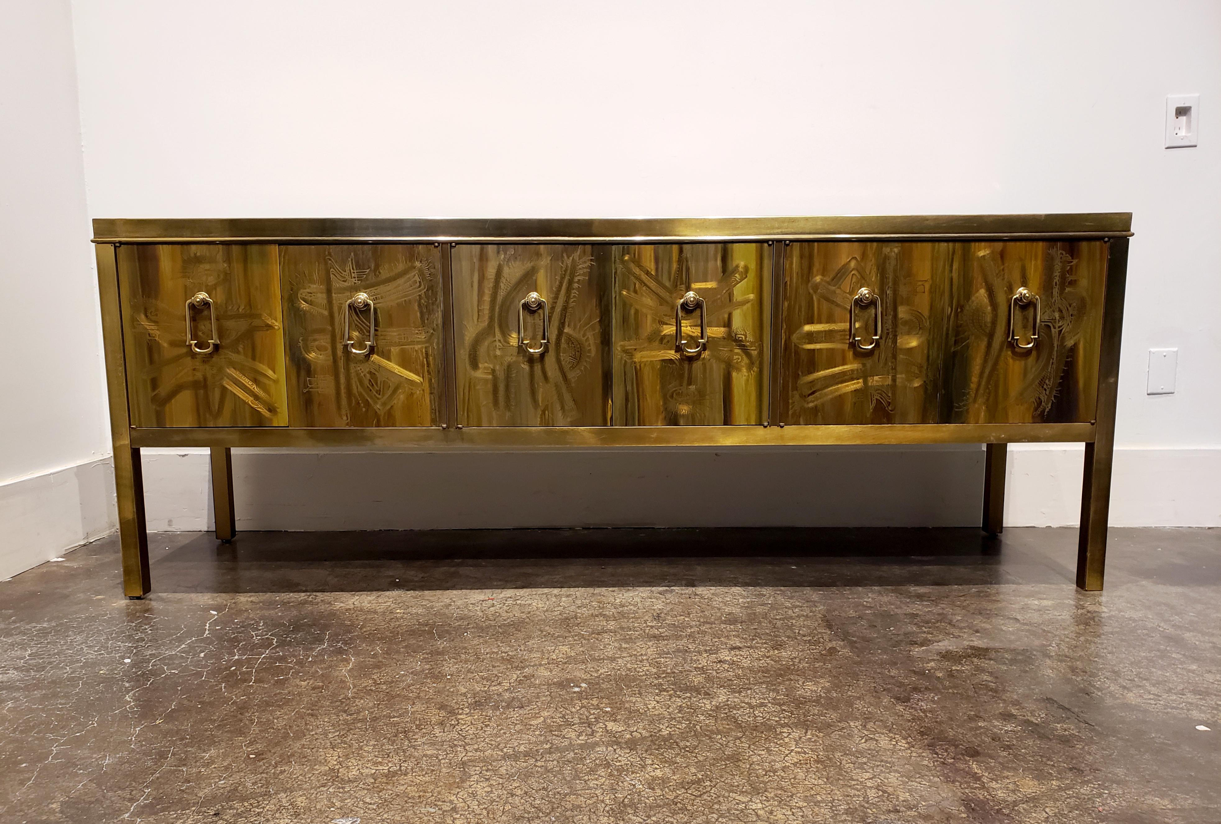 Stunning, all brass dresser from Bernhard Rohne for Mastercraft, circa 1970s. Absolutely unique technique by Rhone; acid-etched panels on doors, side and top accentuated by subtle colored resin/polyurethane finish. Front doors have heavy brass