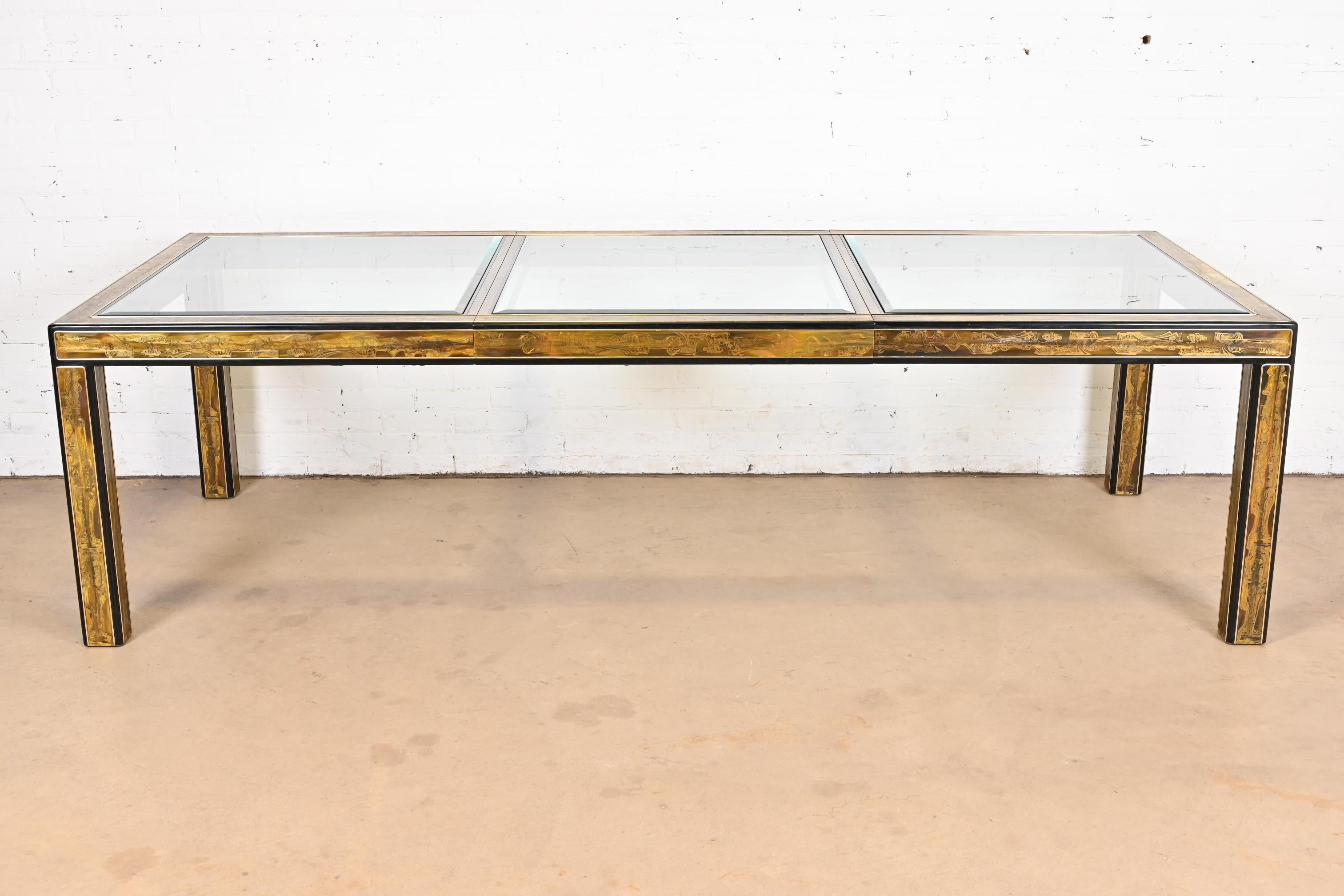 A gorgeous mid-century modern Hollywood Regency extension dining table

By Bernhard Rohne for Mastercraft

USA, 1970s

Acid-etched brass and ebonized wood, with inset beveled glass top.

Measures: 71