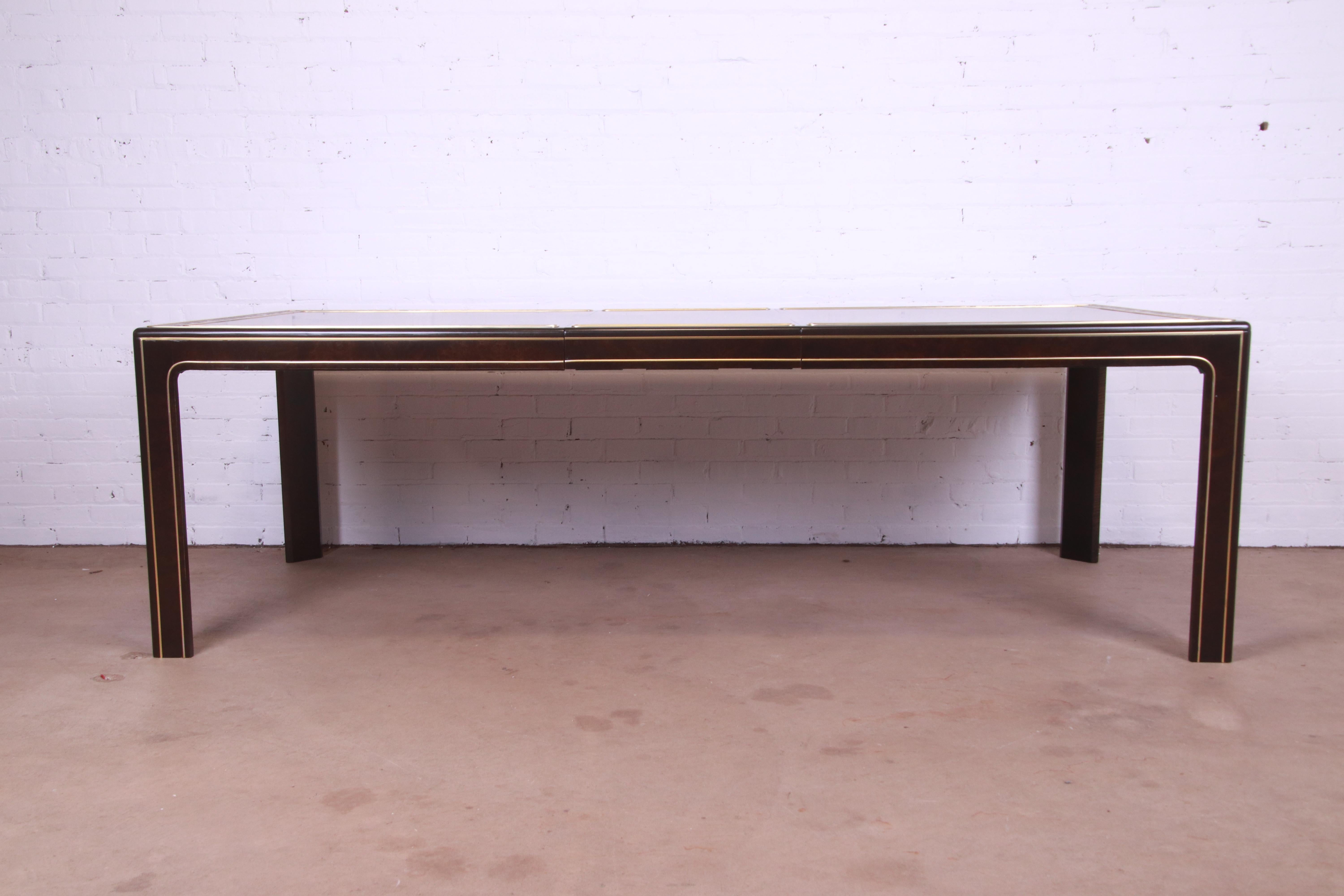 A gorgeous Mid-Century Modern Hollywood Regency extension dining table

By Bernhard Rohne for Mastercraft

USA, 1970s

Burled Carpathian elm wood, with acid-etched brass border.

Measures: 74