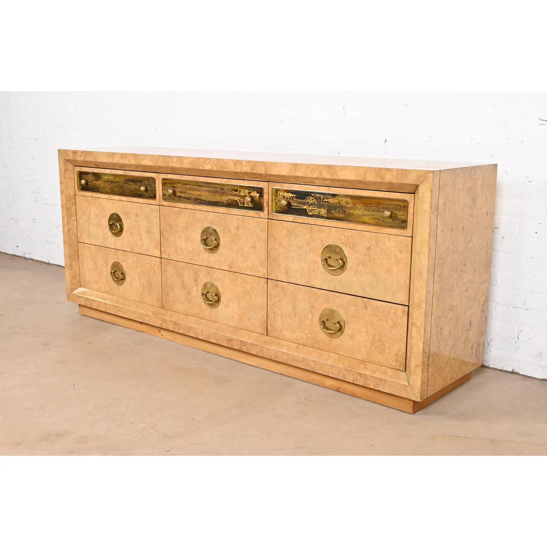 A gorgeous mid-century modern Hollywood Regency triple dresser or credenza

By Bernhard Rohne for Mastercraft Furniture

USA, 1970s

Burled Carpathian elm wood, with acid etched brass drawer fronts and original brass hardware.

Measures: 78