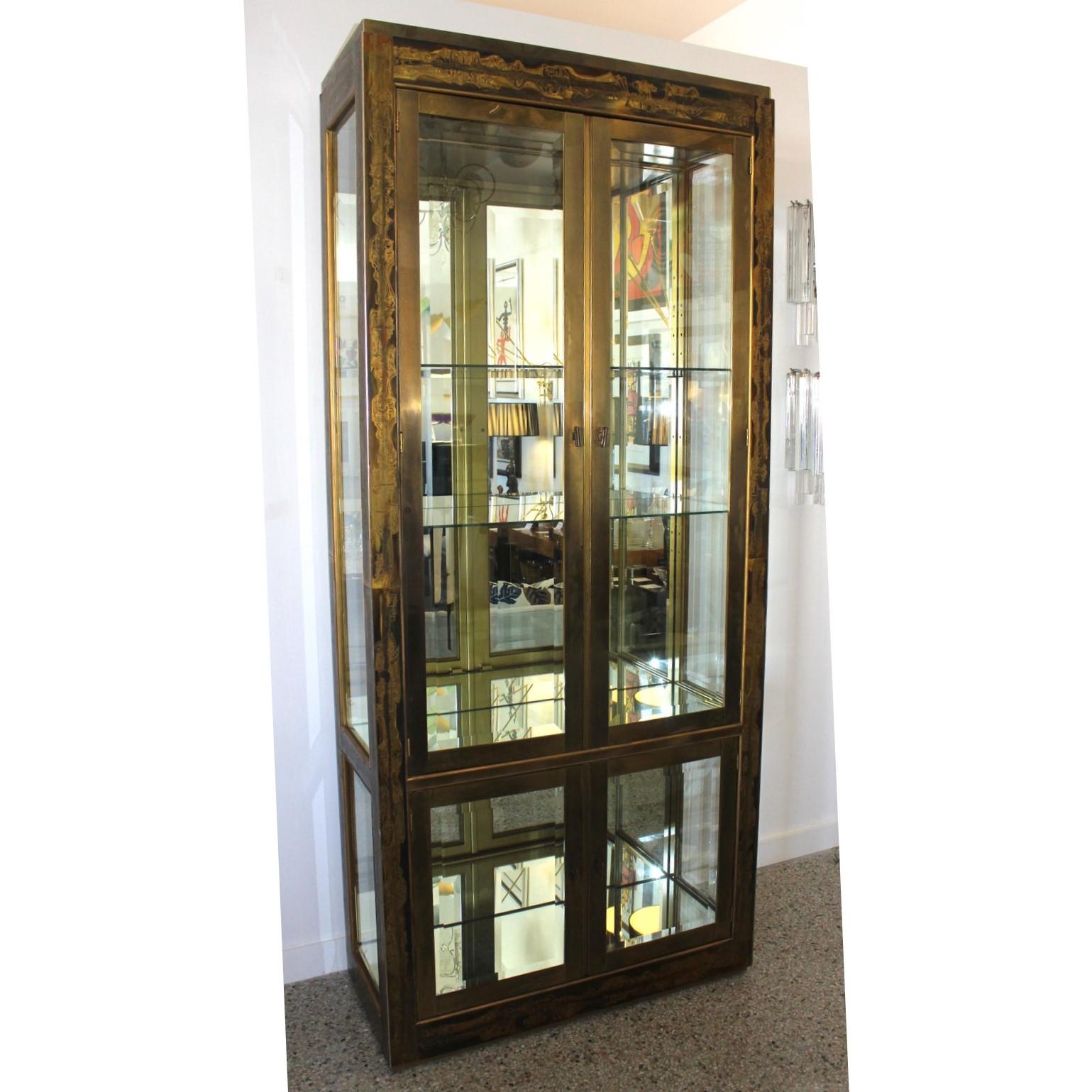 Vintage Bernhard Rohne for Mastercraft Display Cabinet in Anodized aluminum and brass - from a Palm Beach estate -- design of inside lights and mirrors enhances your collections.
The electric cord in the back has an on-off switch for the 2 inside
