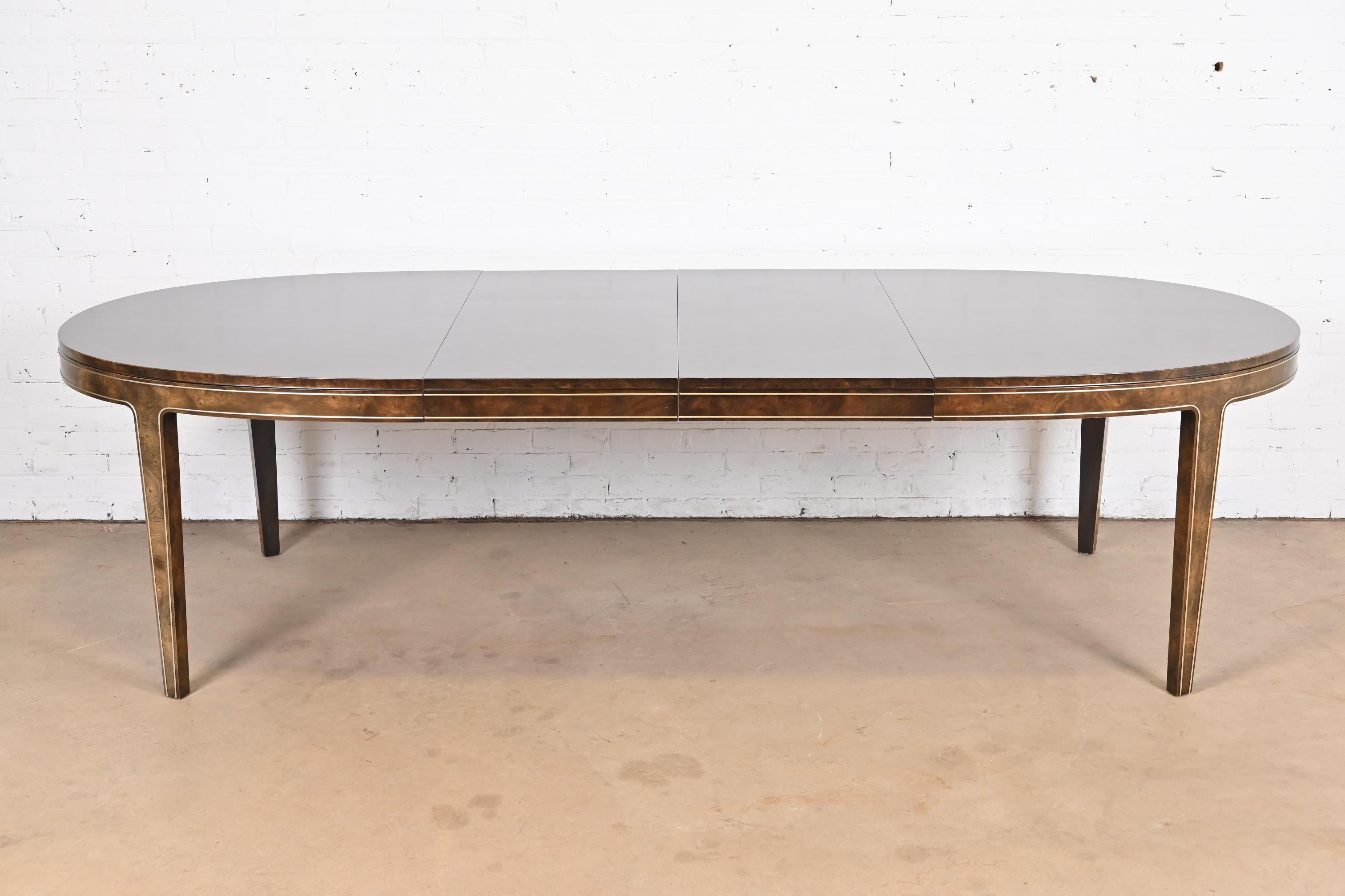 A gorgeous Mid-Century Modern Hollywood Regency extension dining table

By Bernhard Rohne for Mastercraft Furniture

USA, 1970s

Beautiful burled Carpathian elm wood, with inlaid brass trim.

Measures: 69.75