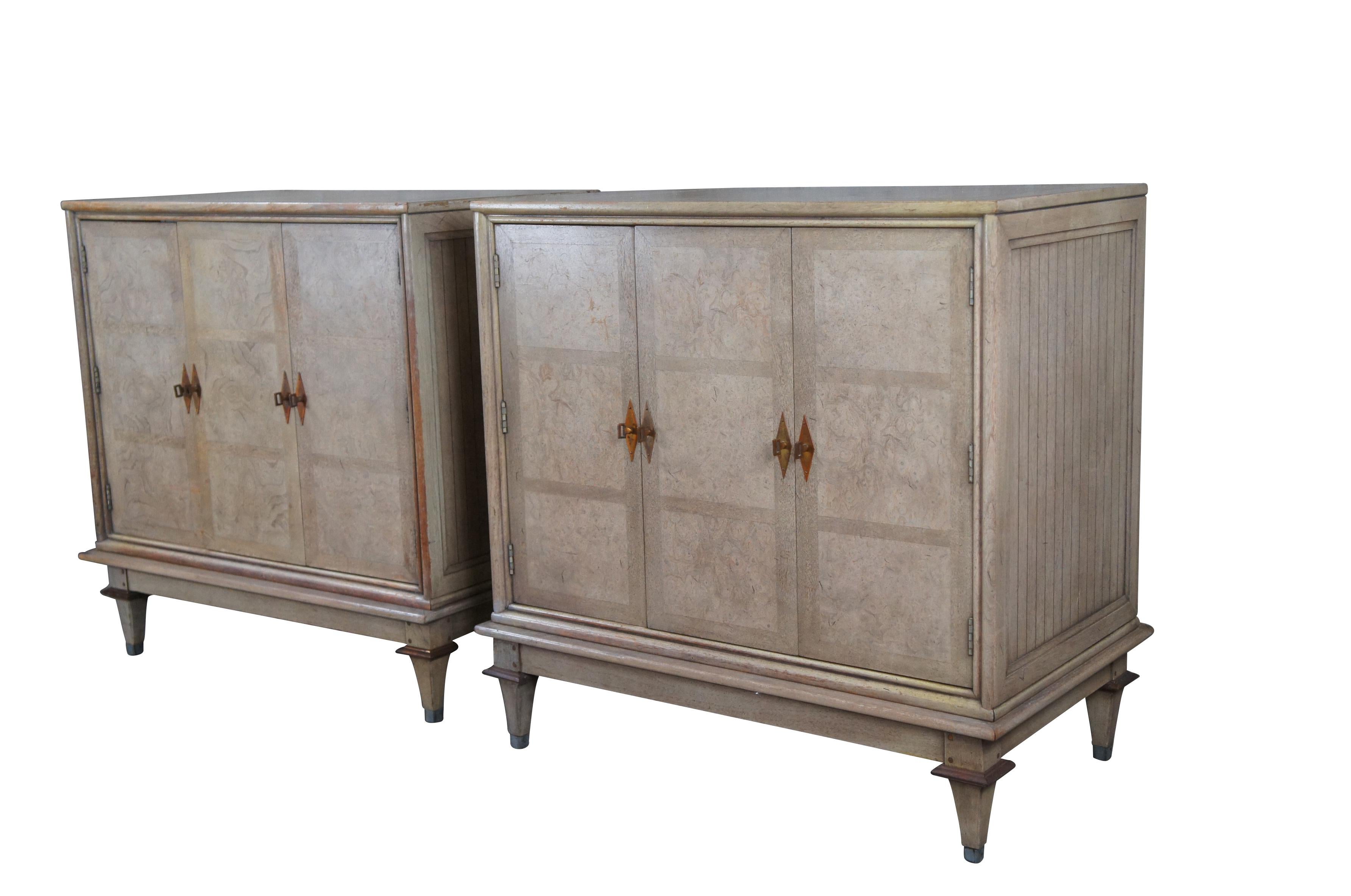 Pair of mid century modern buffets / credenzas / sideboards / servers / nightstands by Bernhard Rohne for Mastercraft Furniture Company.  Made from ash burl featuring modular form with paneled sides, folding doors, dovetailed drawers and silverware