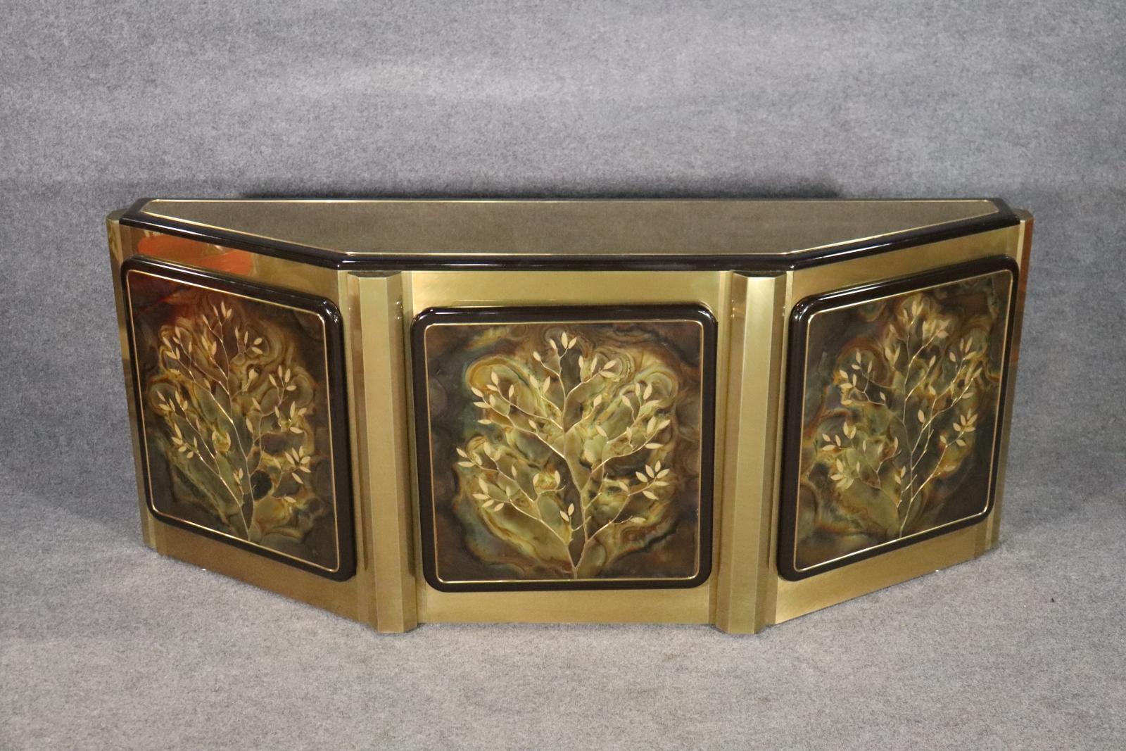 Etched brass panel doors with brass clad base. 3 doors containing 1 shelf. 30 1/8