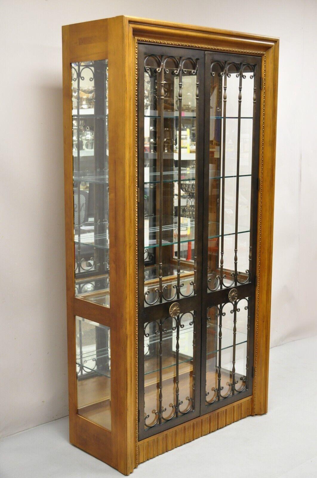 Bernhardt 354-356 Modern Cherry Wood & Iron Door Mediterranean Modern Lighted Curio China Display Cabinet. Item features Mirror back, ornate iron doors, touch light with 3 illumination settings, 4 adjustable glass shelves and 1 fixed glass shelf,