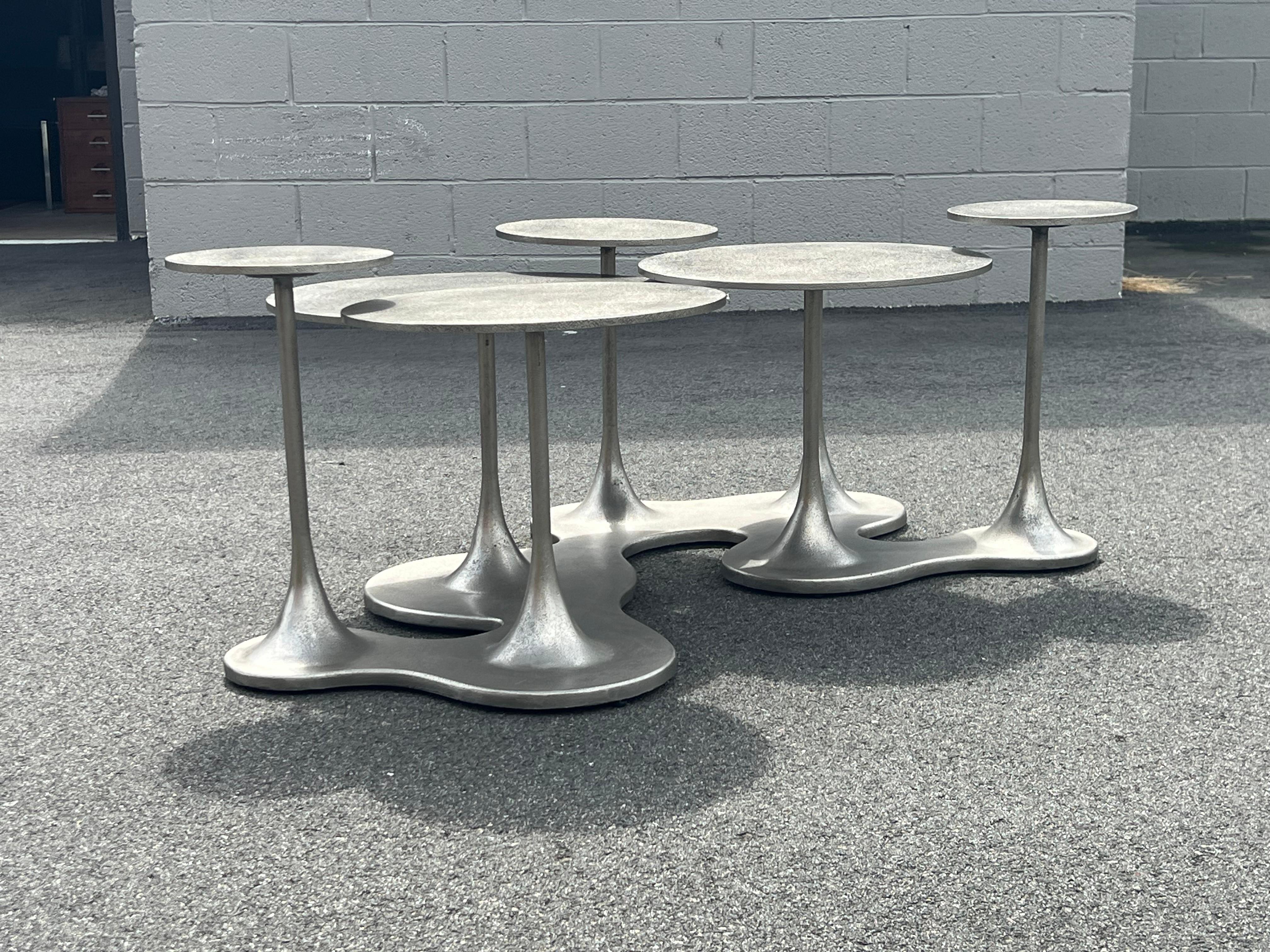 Unique aluminum coffee table manufactured and designed by Bernhardt, USA. Round circlets are layered and distributed across the top. Each circlet has a tulip style stem that gradually tapers to the base. The base of the coffee table is a free form